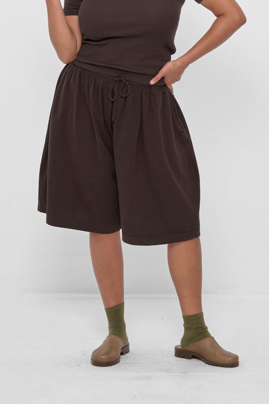 Long Tubular Shorts in Wet Soil – front view on model