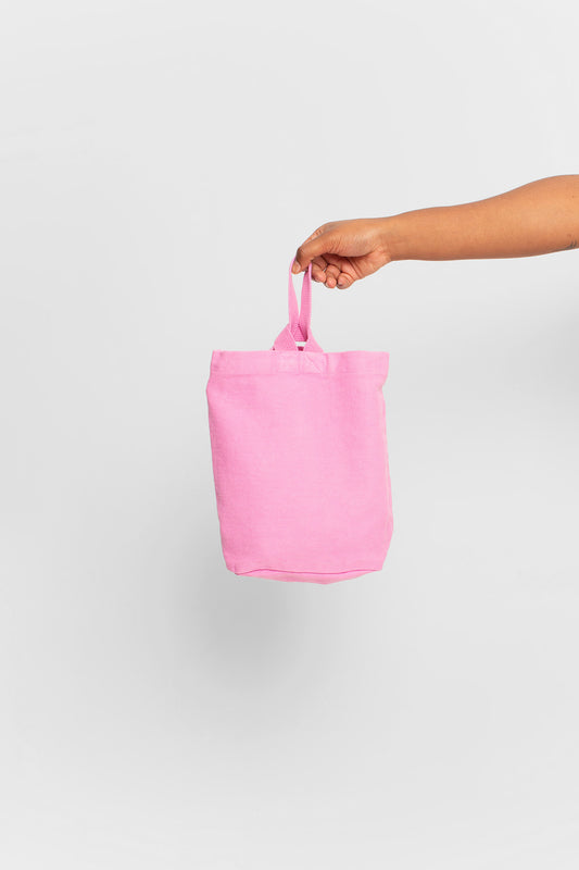 Pixie Loop Tote: longer strap front-facing, hand-held, showing gussets, depth, and stitching.