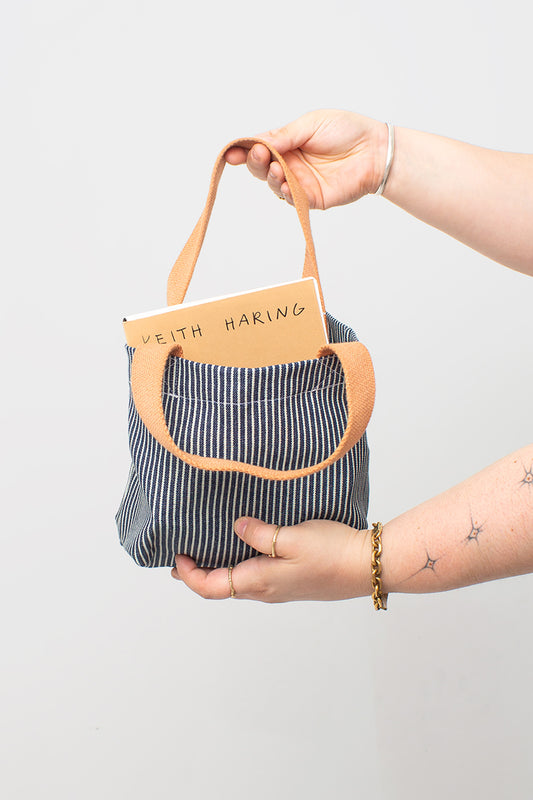 Held by one strap, notebook inside.