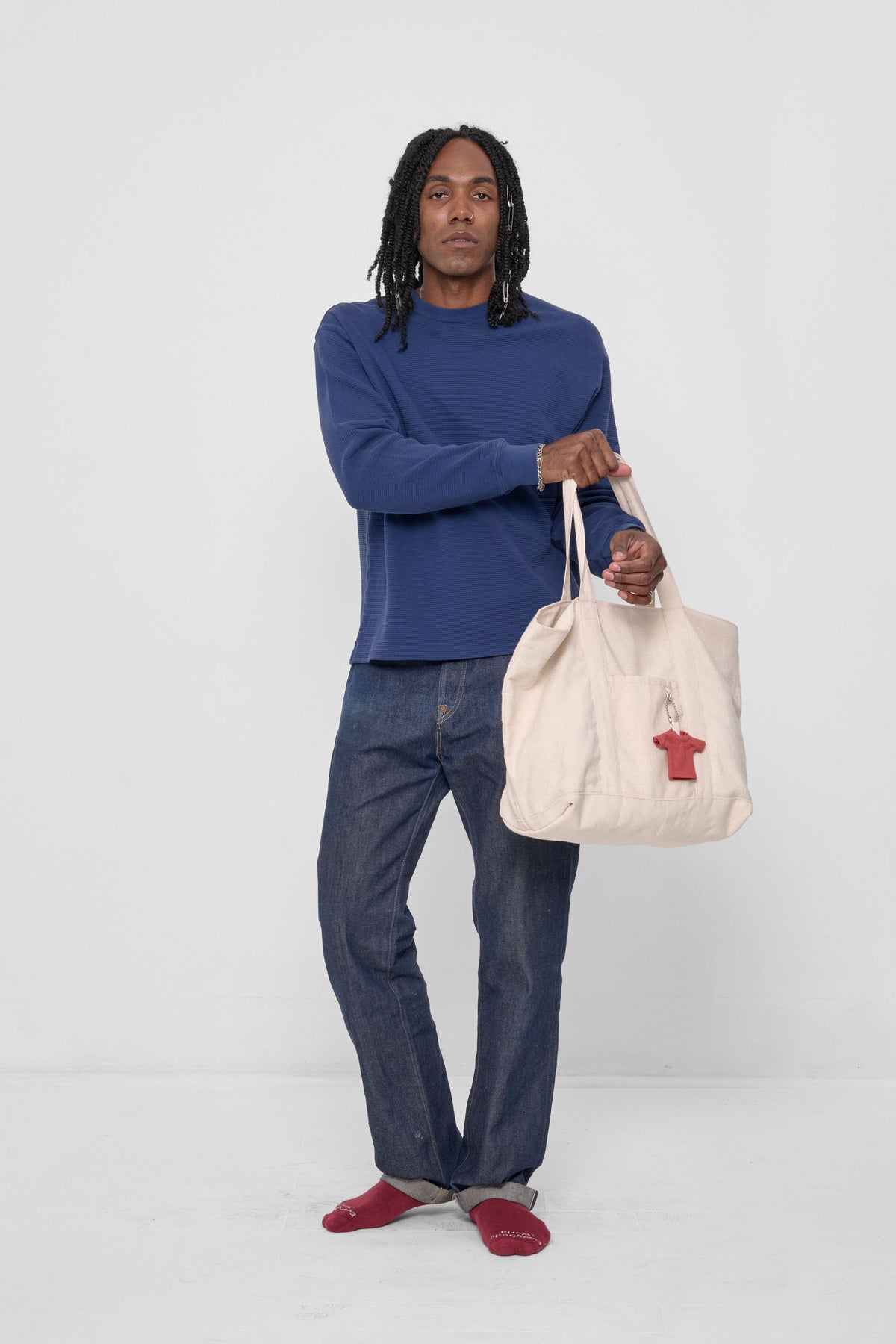 Overnight Tote being pulled onto model's arm, for scale.
