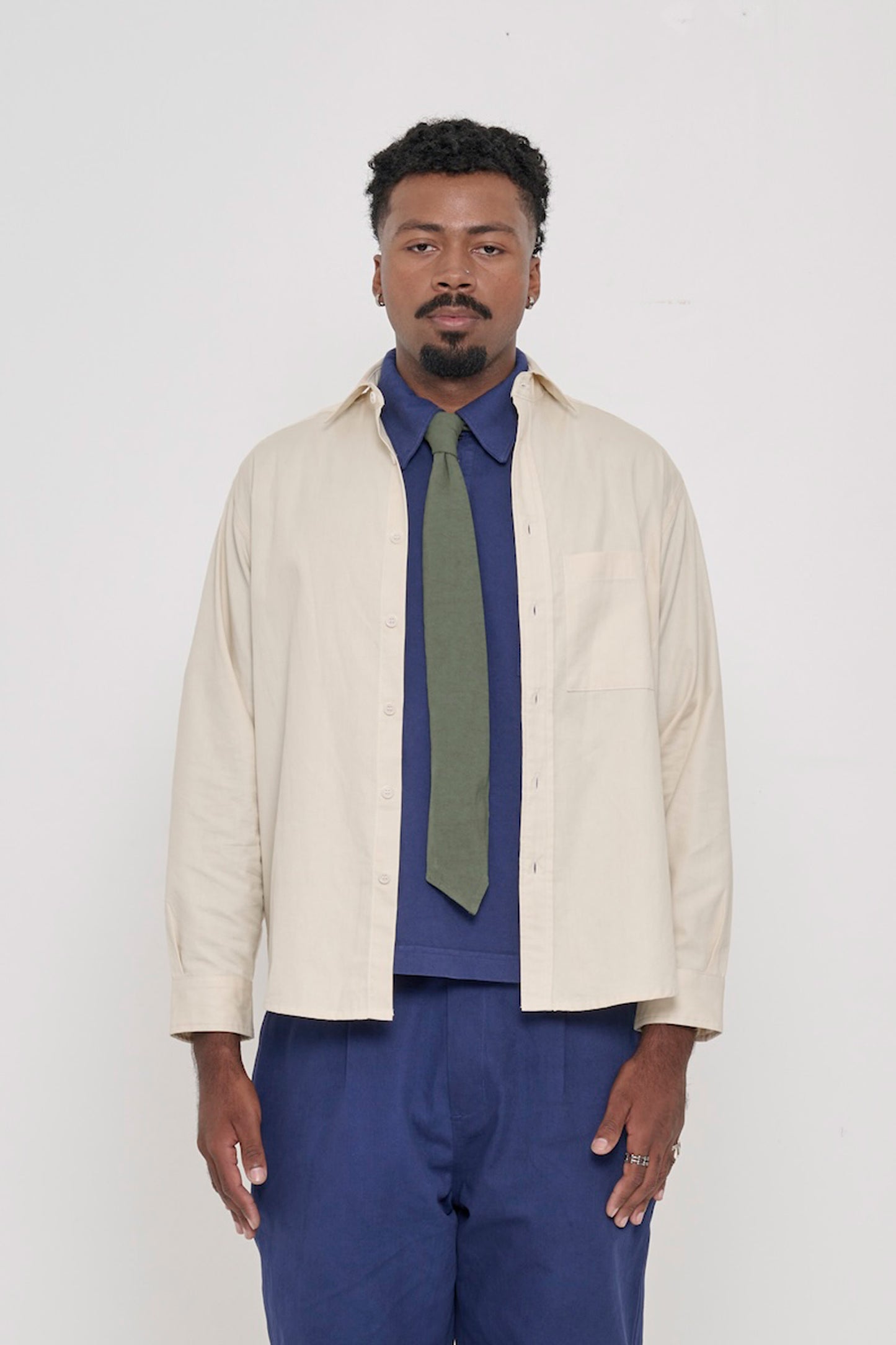 Oat Peach Fuzz Twill Button Up Shirt, worn open, with Washed Navy Trash Polo, Pine Green Trash Tie.