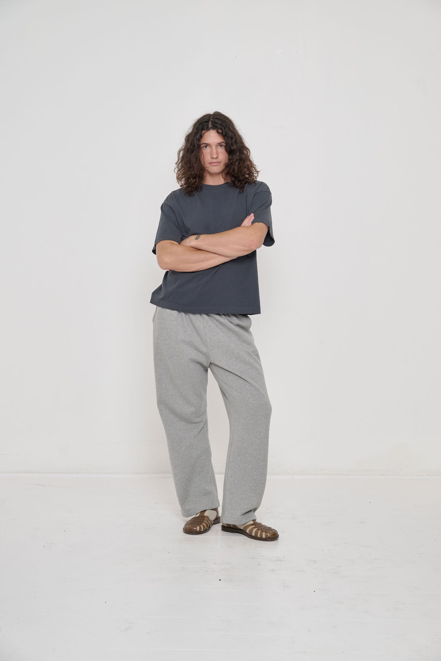 Model wearing Hemp Plasticana Sandana Jelly Sandal with Heather Sweatpants and Oat Spring Socks.