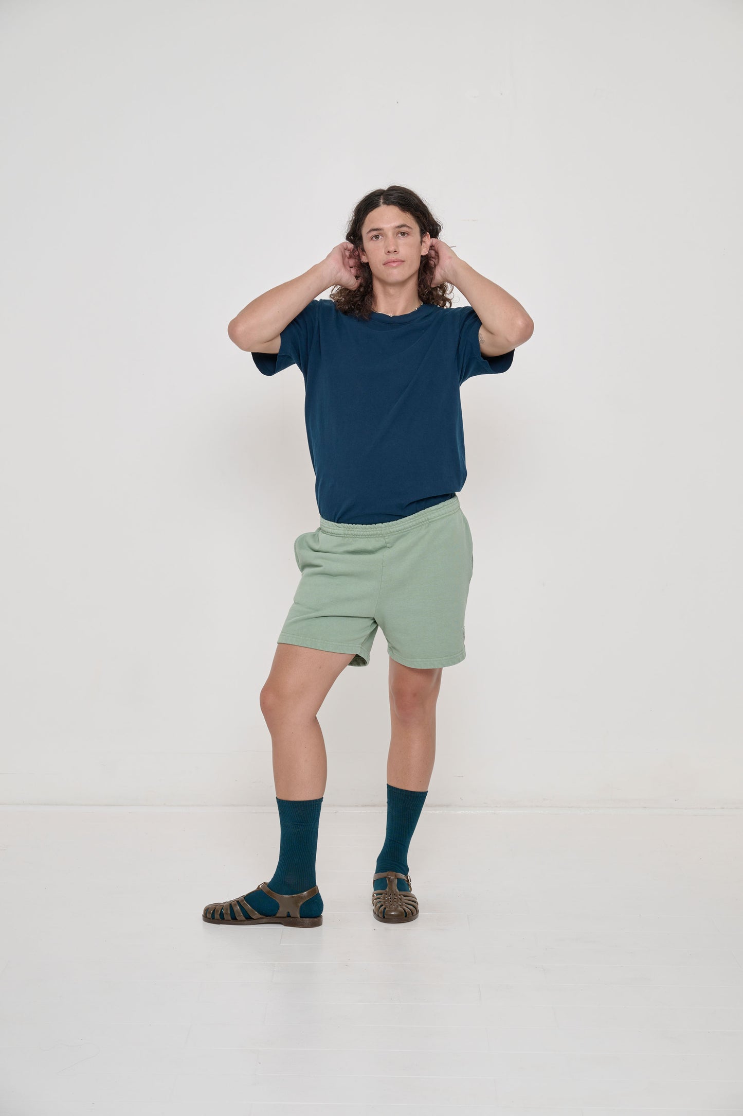 Model wearing Hemp Plasticana Sandana Jelly Sandal with Juniper Squishy Socks and Juniper Short Sleeve Trash Tee.