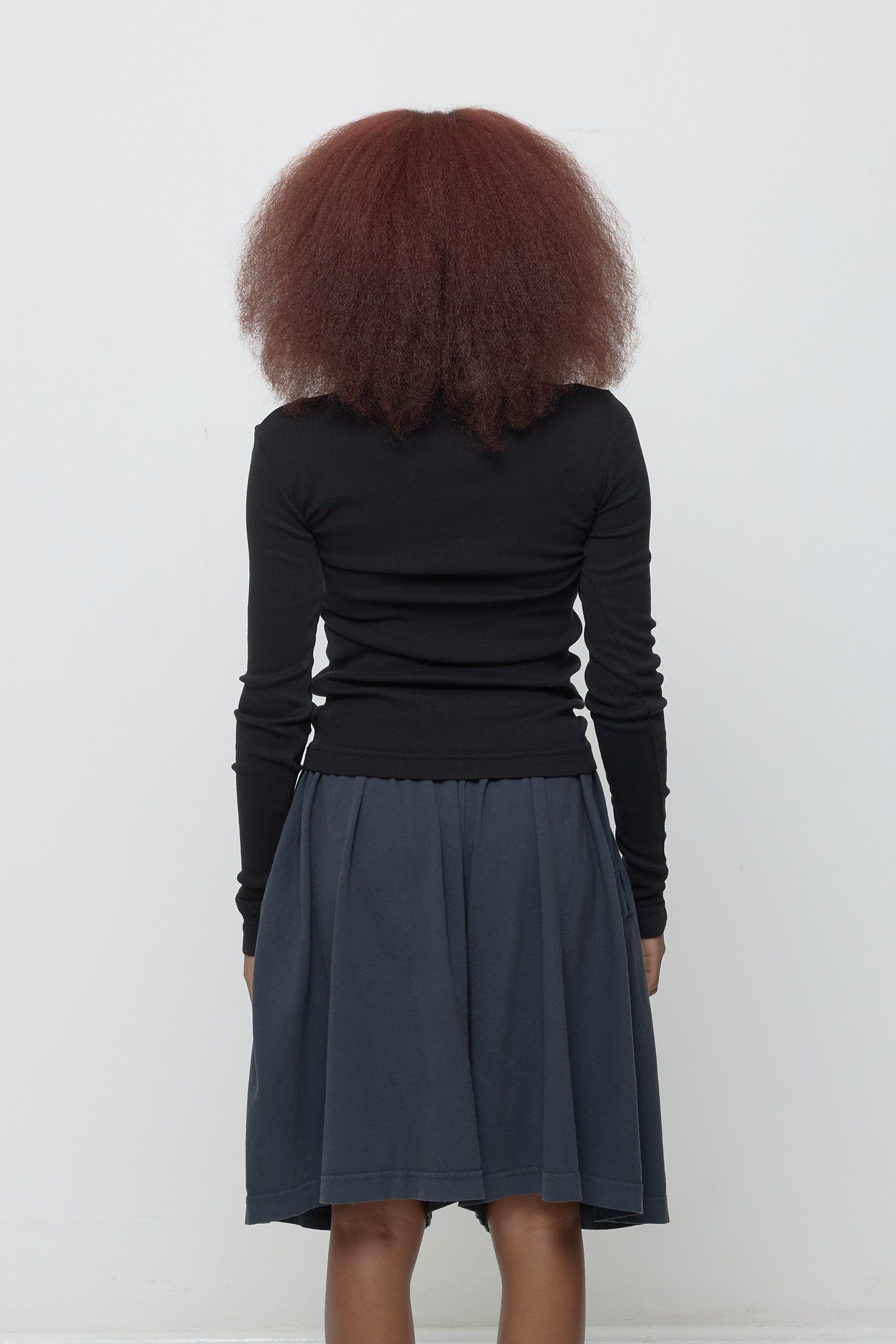Back view: Fitted across the upper back with a little bit of ease across her mid to lower back.