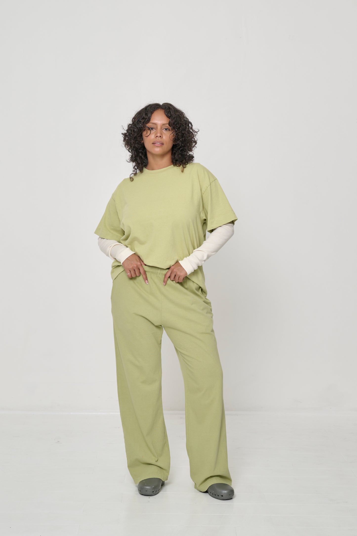Woman wearing a Boxier Trash Tee over a Rib Long Sleeve, which is visible from the elbow down.