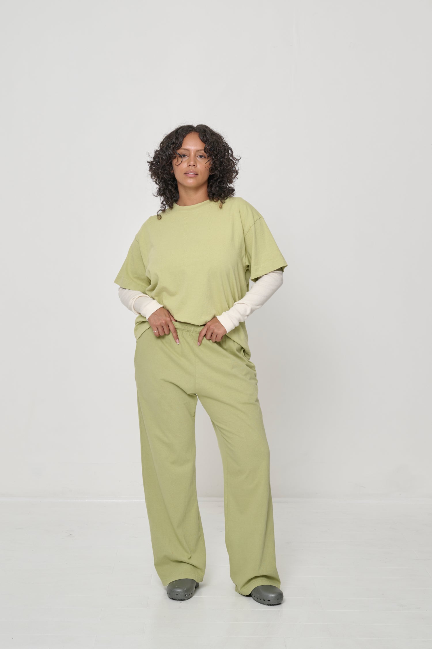 Woman wearing a Boxier Trash Tee over a Rib Long Sleeve, which is visible from the elbow down.
