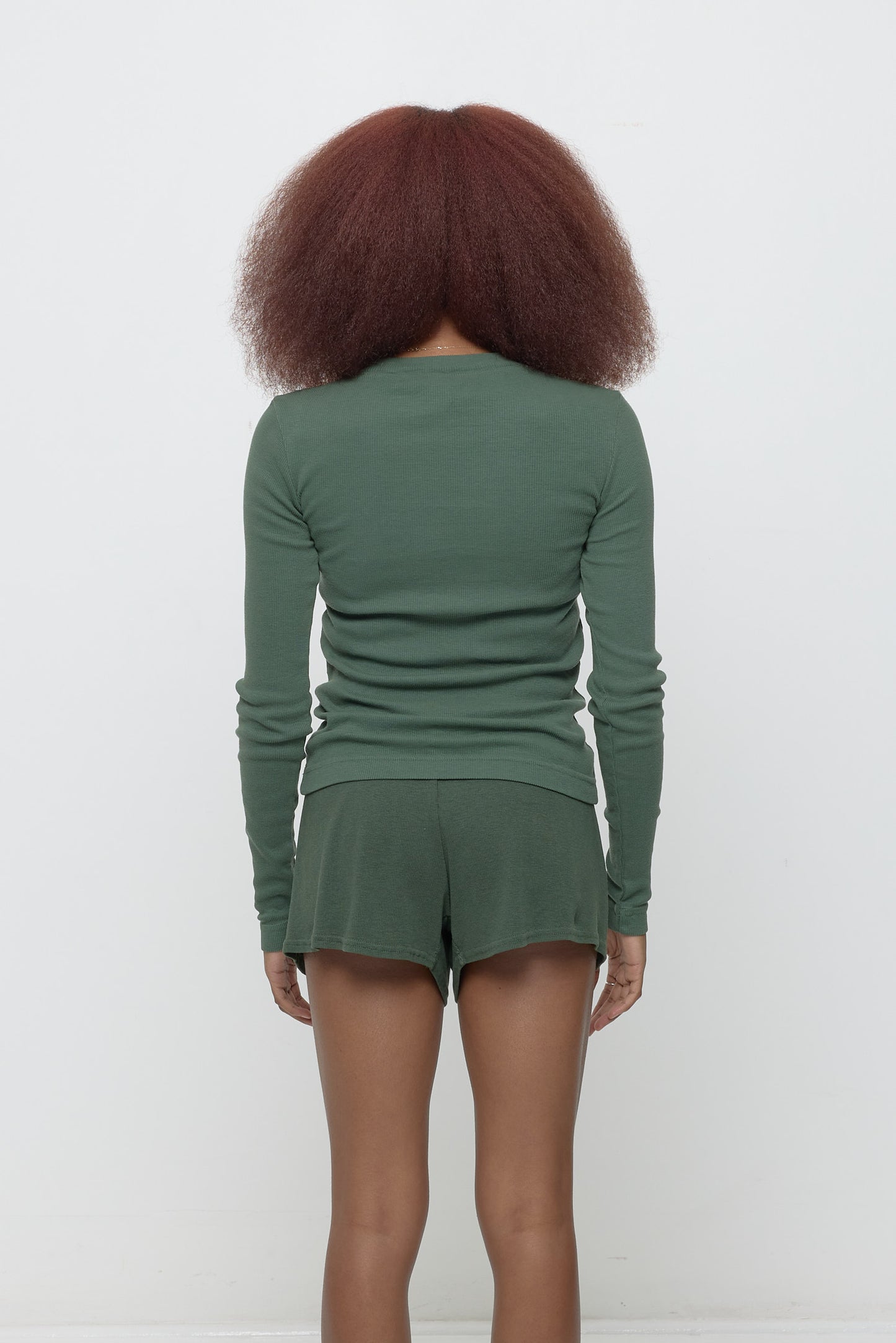 Back view: Fitted across the upper back with a little bit of ease across her mid to lower back.