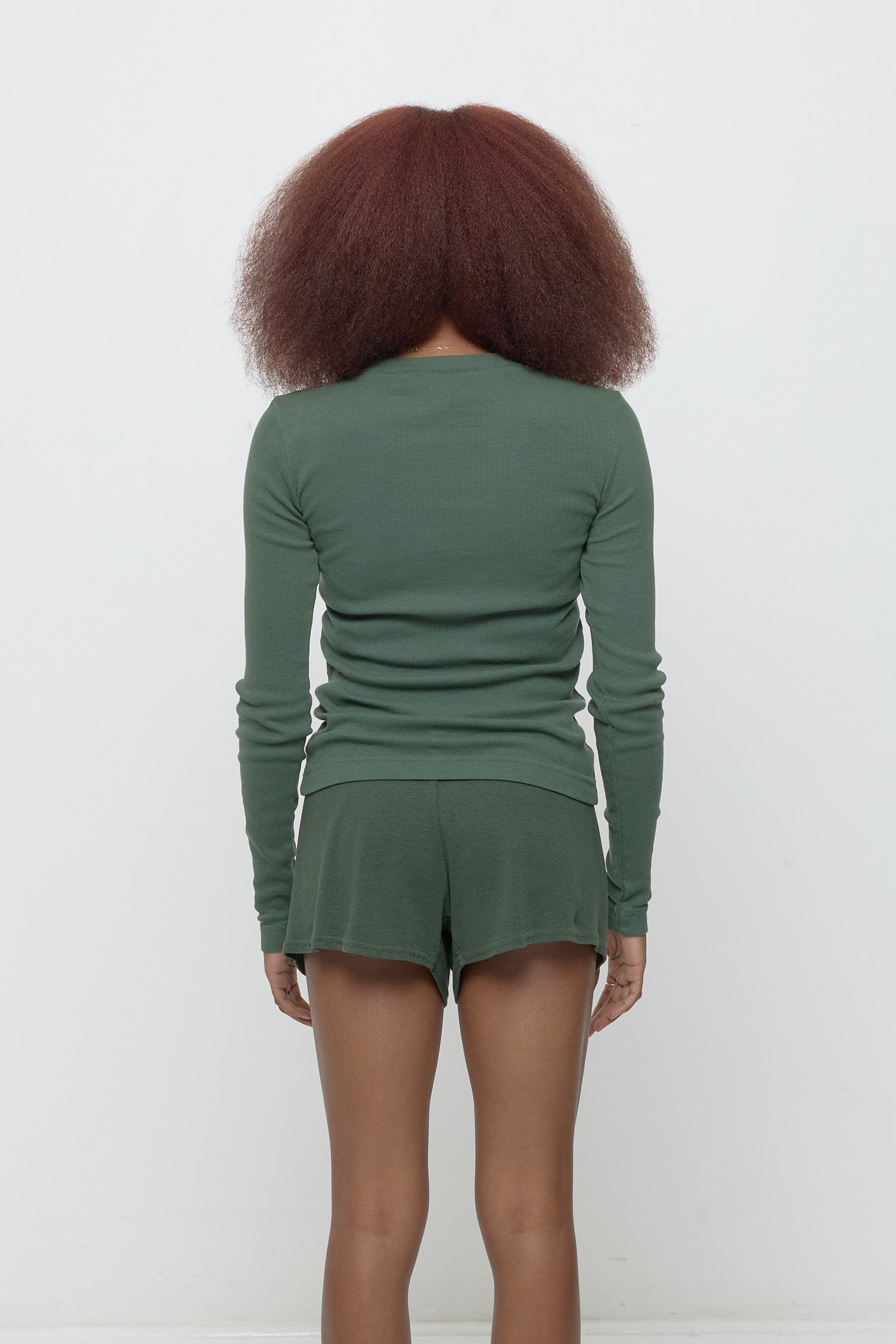 Back view: Fitted across the upper back with a little bit of ease across her mid to lower back.