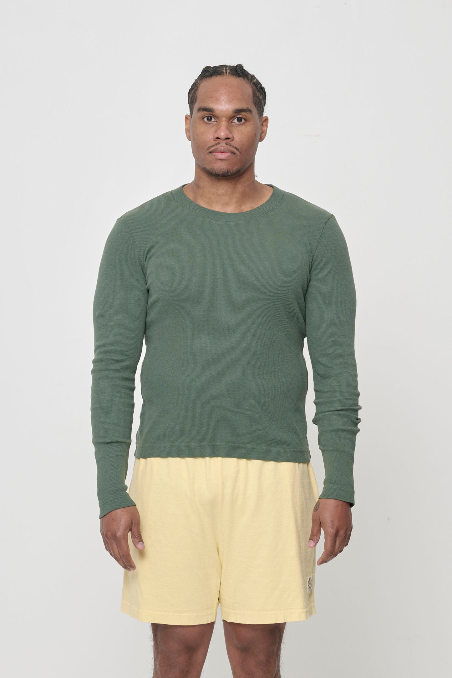 A 6' man wearing a size XL Pine Rib Long Sleeve, with hem hitting his hips.