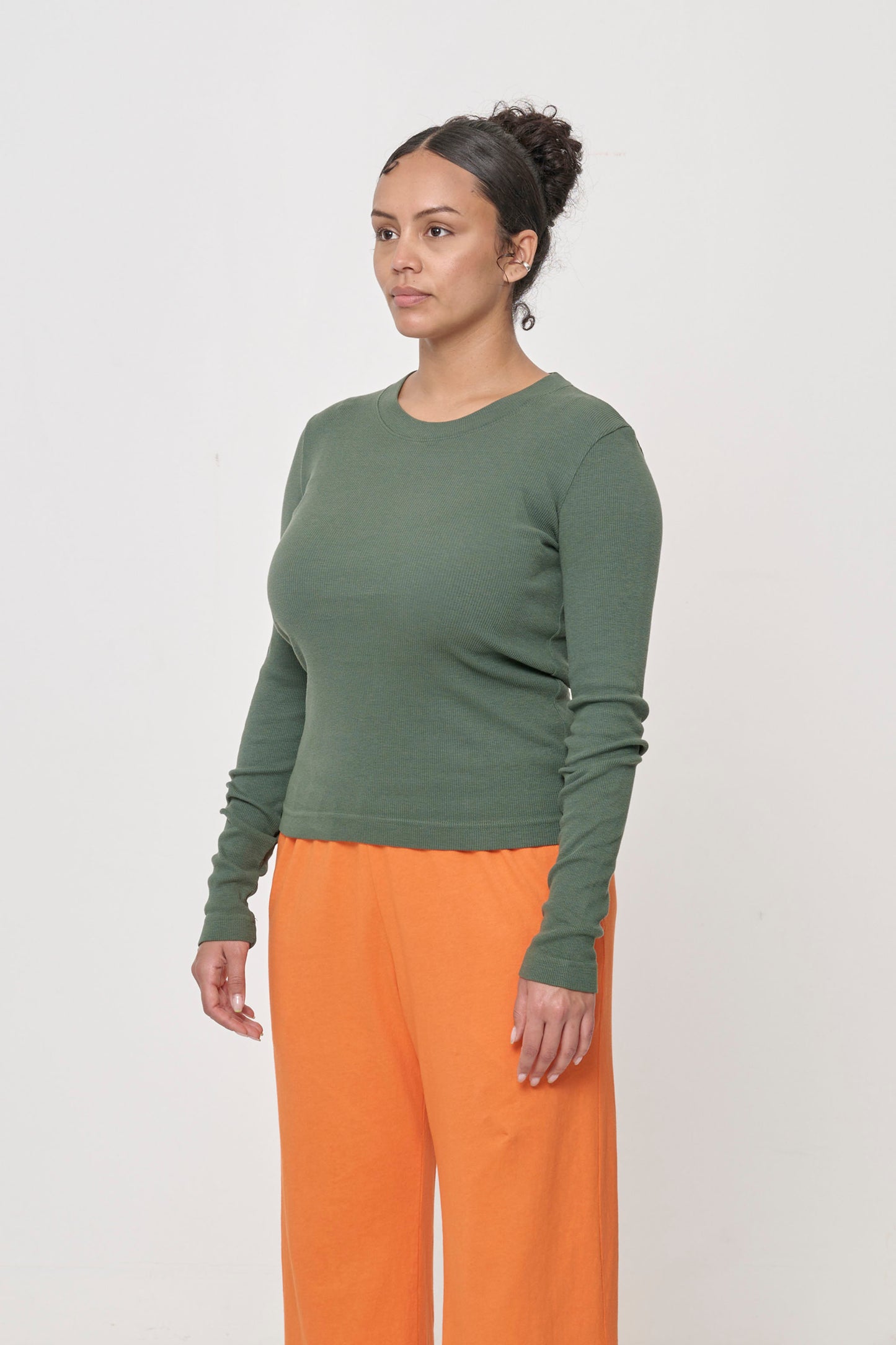 A person turned 45-degrees from the front showing the side seams and fitted silhouette.