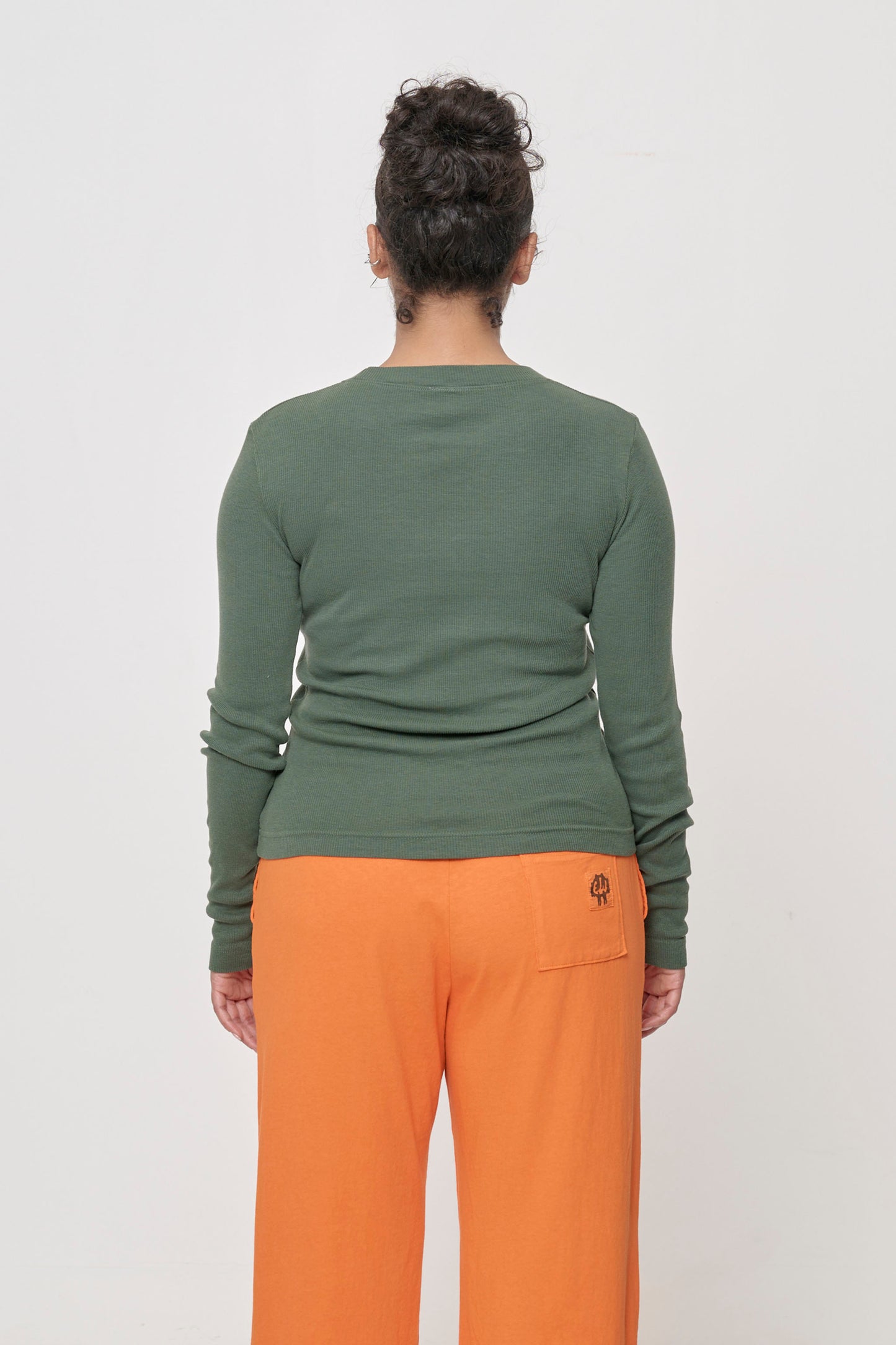 Back view: Fitted across the upper back with a little bit ease across her lower back.