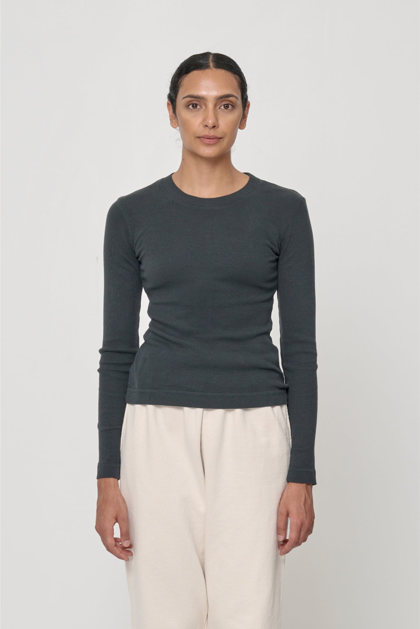 Front view of a 5'10" woman wearing a size S Rib Long Sleeve in Slate, and hem hits the top of her hips.