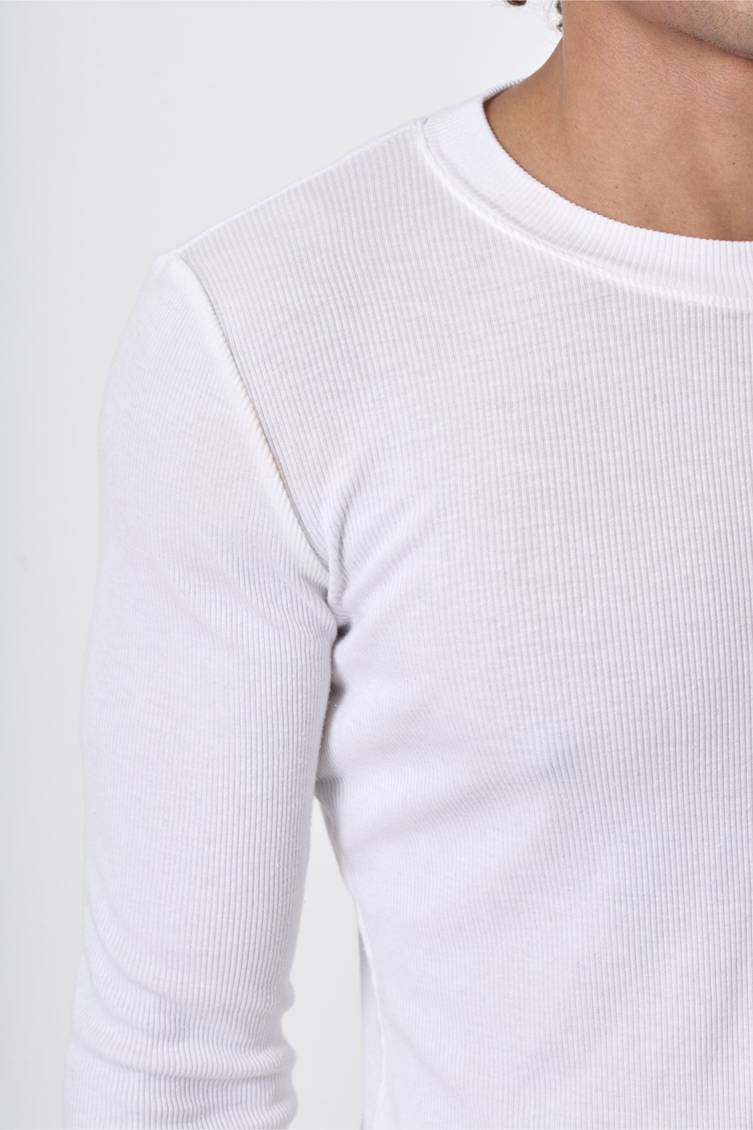 Close-up showing the fine ribbed texture and crew neckline.