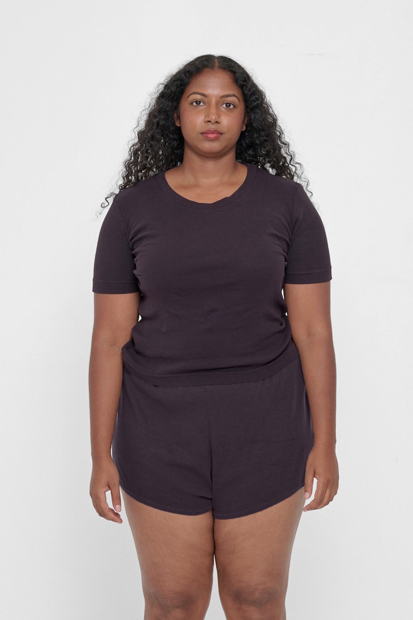 Front view of a 5'8" woman wearing a Rib Short Sleeve in Mulberry. Hem rests on her upper hips.