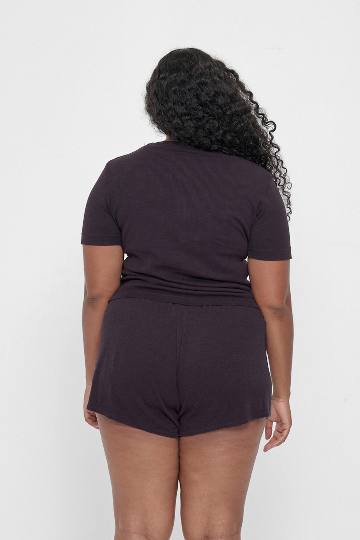 Back view: woman in Mulberry Rib Short Sleeve, showcasing the formfitting silhouette
