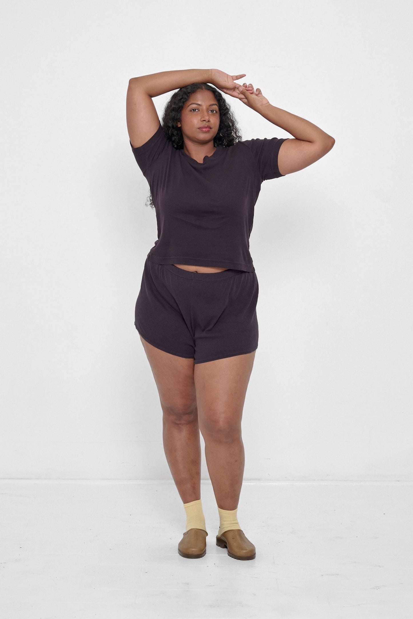 Woman in a Mulberry Rib Short Sleeve and matching Rib Shorts with Plasticana Opana Mules.