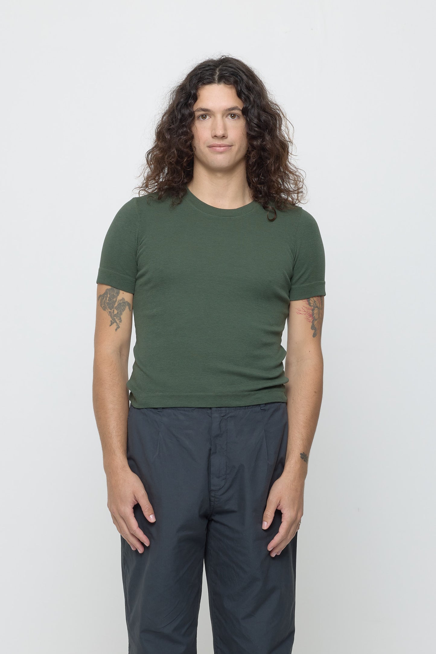 Front view of a 6' person wearing a size XL Rib Short Sleeve in Pine. Hem rests just about their hips.
