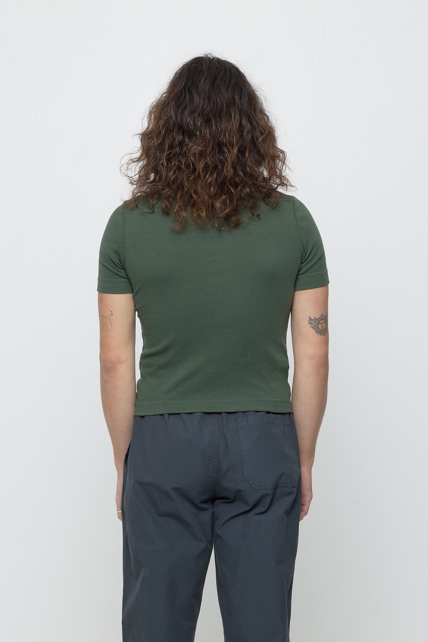 Back view: person in Pine Rib Short Sleeve, fitted silhouette.