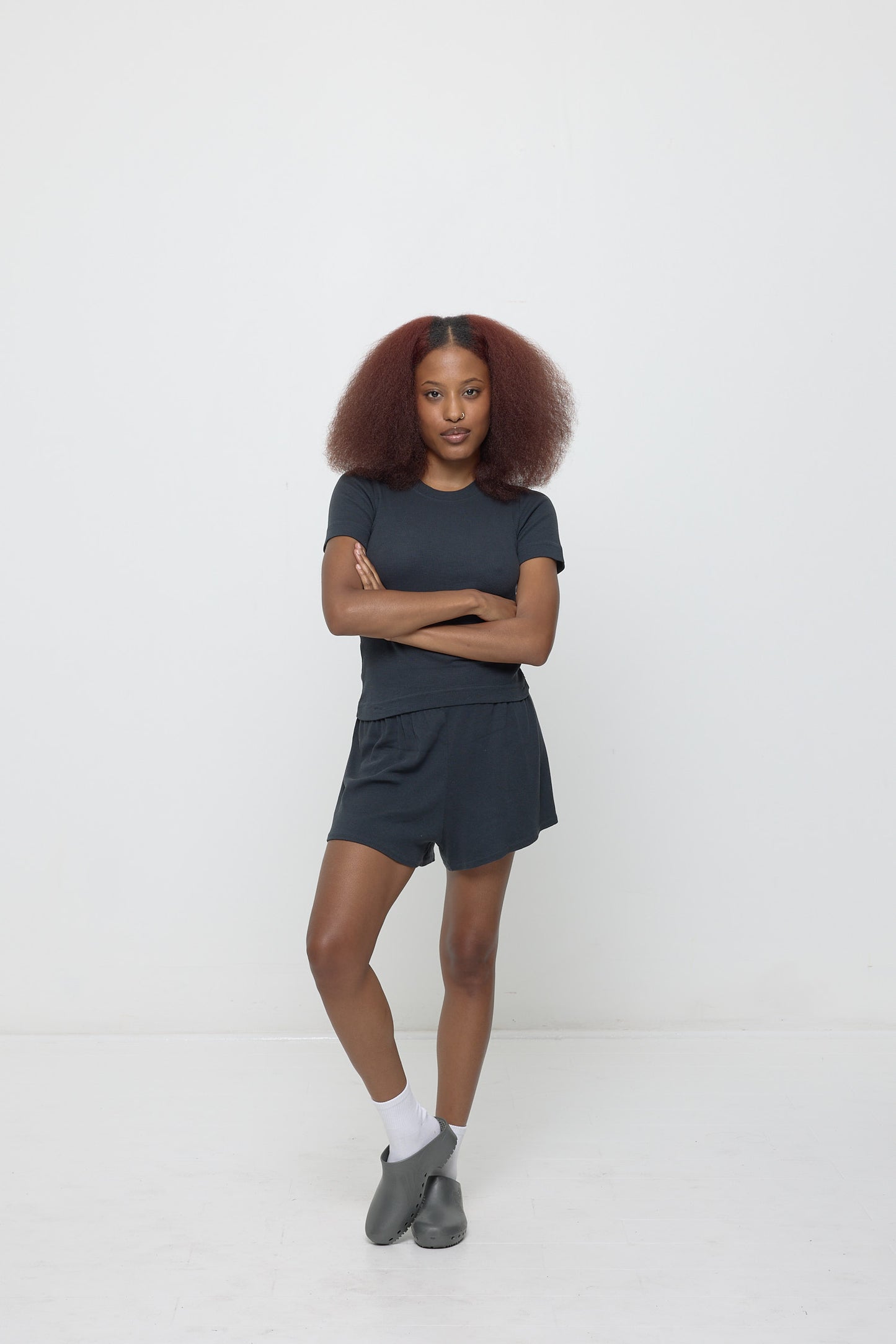 Woman in a Slate Rib Short Sleeve and matching Rib Shorts with Metallic Grey Calzuro Classic Clogs.