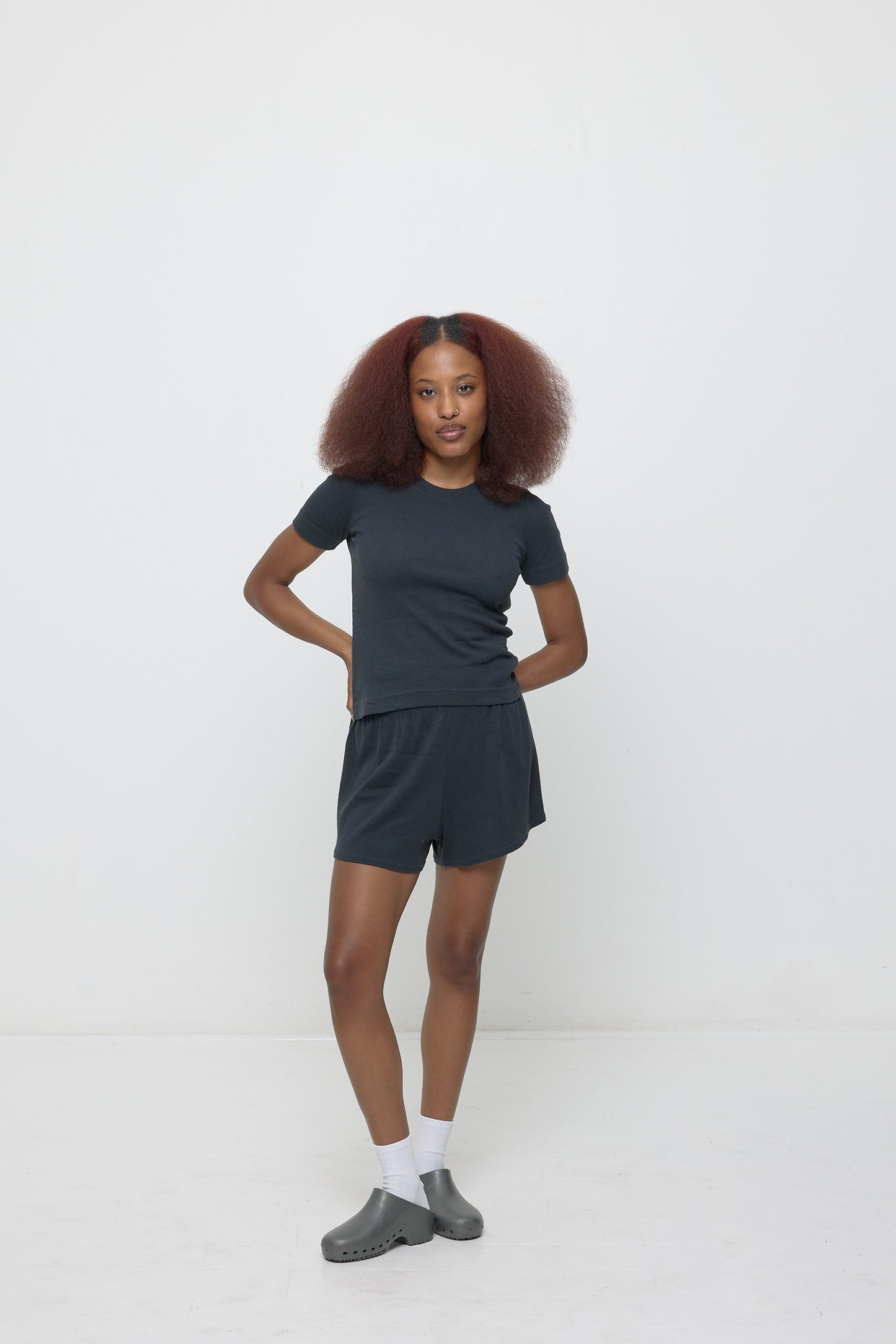 A person wearing Slate Rib Shorts with a matching Rib Short Sleeve.