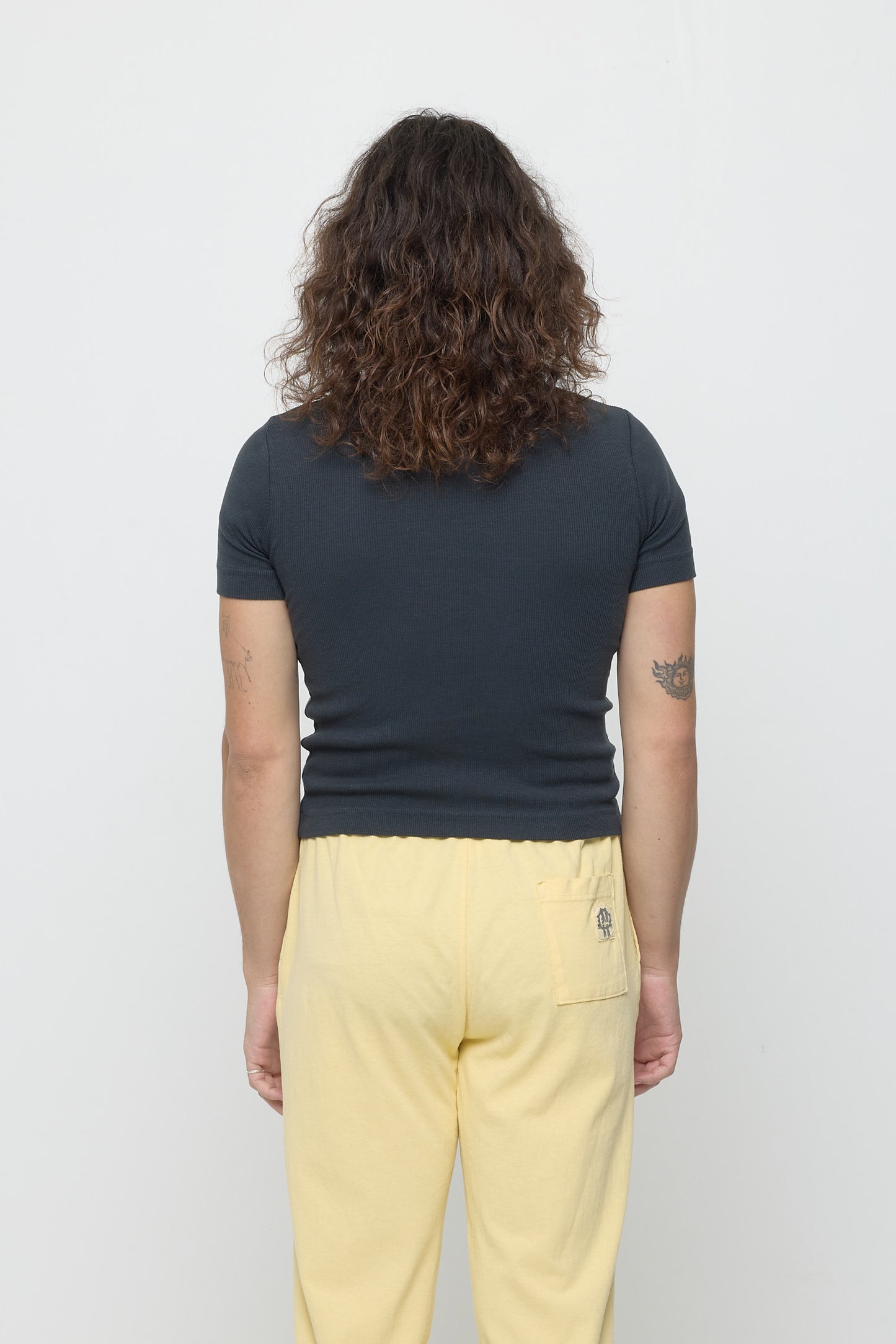 Back view: person in Slate Rib Short Sleeve, fitted silhouette.