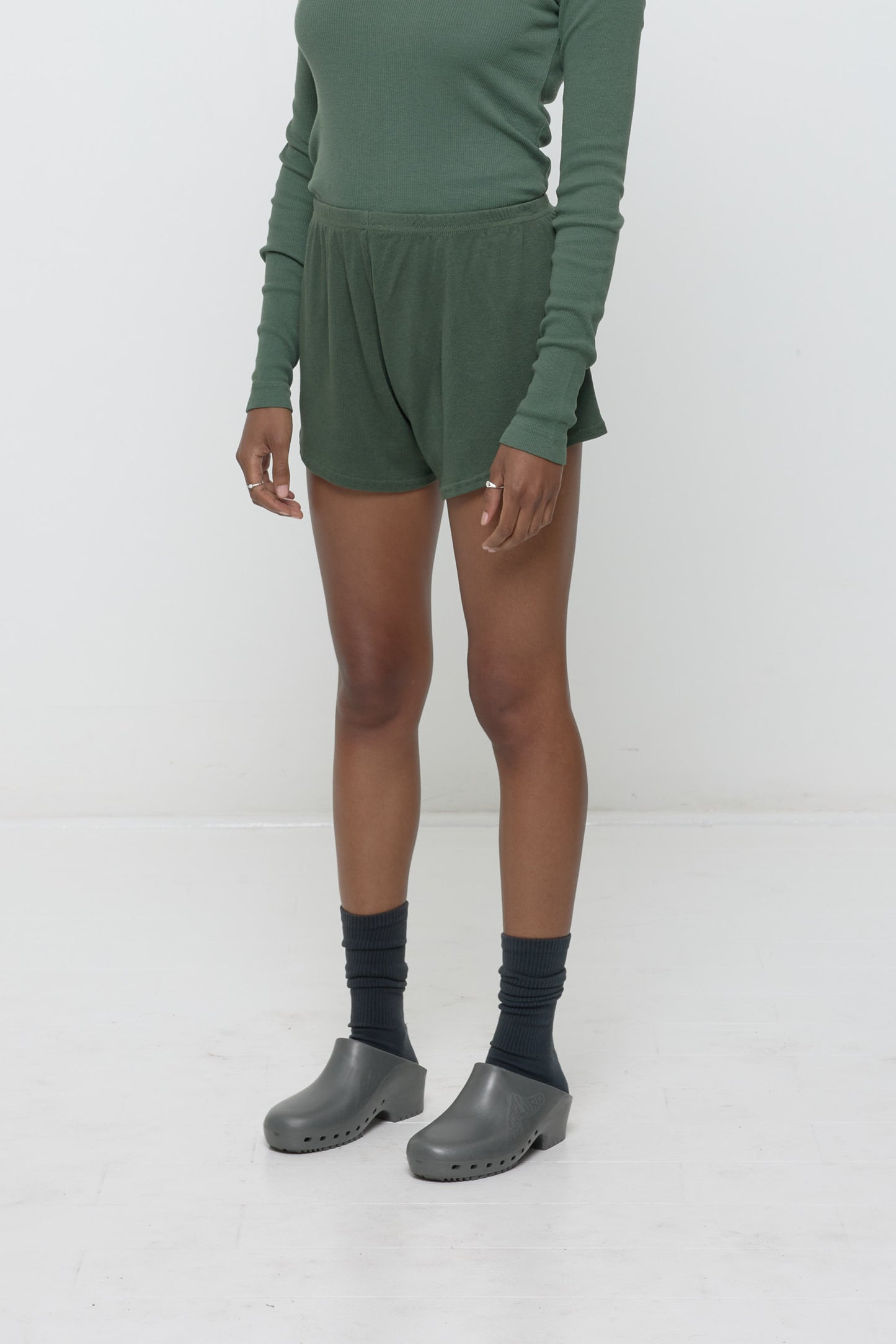 A person facing 45-degrees, wearing Pine Rib Shorts, showcasing spacious leg openings.