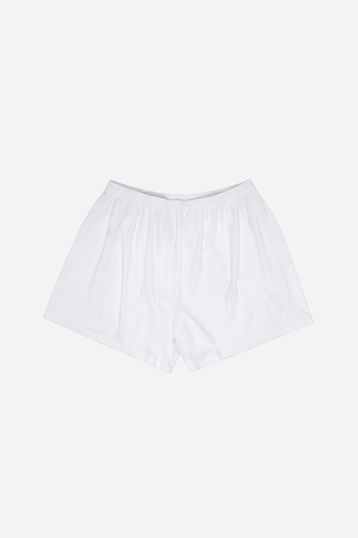 Flat lay of White Rib Shorts showing slight gathers from the waist that give the shorts the relaxed fit.