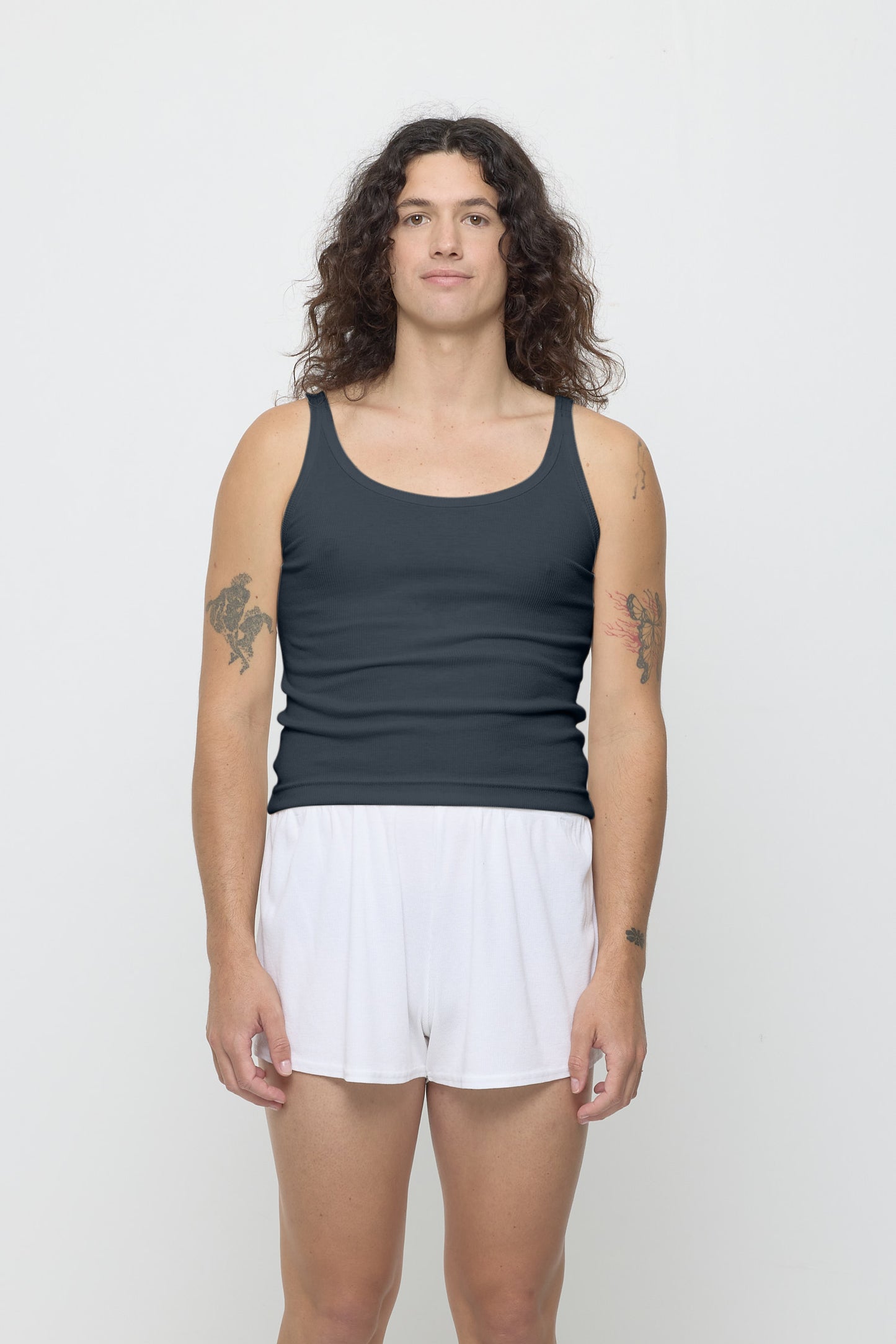 Front view of a 6' person wearing a size S Rib Tank in Slate. Hem rests on their upper hips.