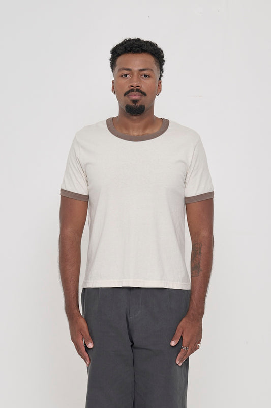 A 6'2" man in a size 2XL Ringer Trash Tee in Dry Soil. Hem hits his upper hip.