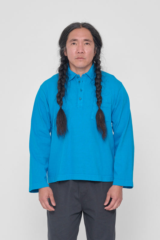 A 5'11" man in a size L Malibu Rugby Trash Polo. Hem ends at mid hip.