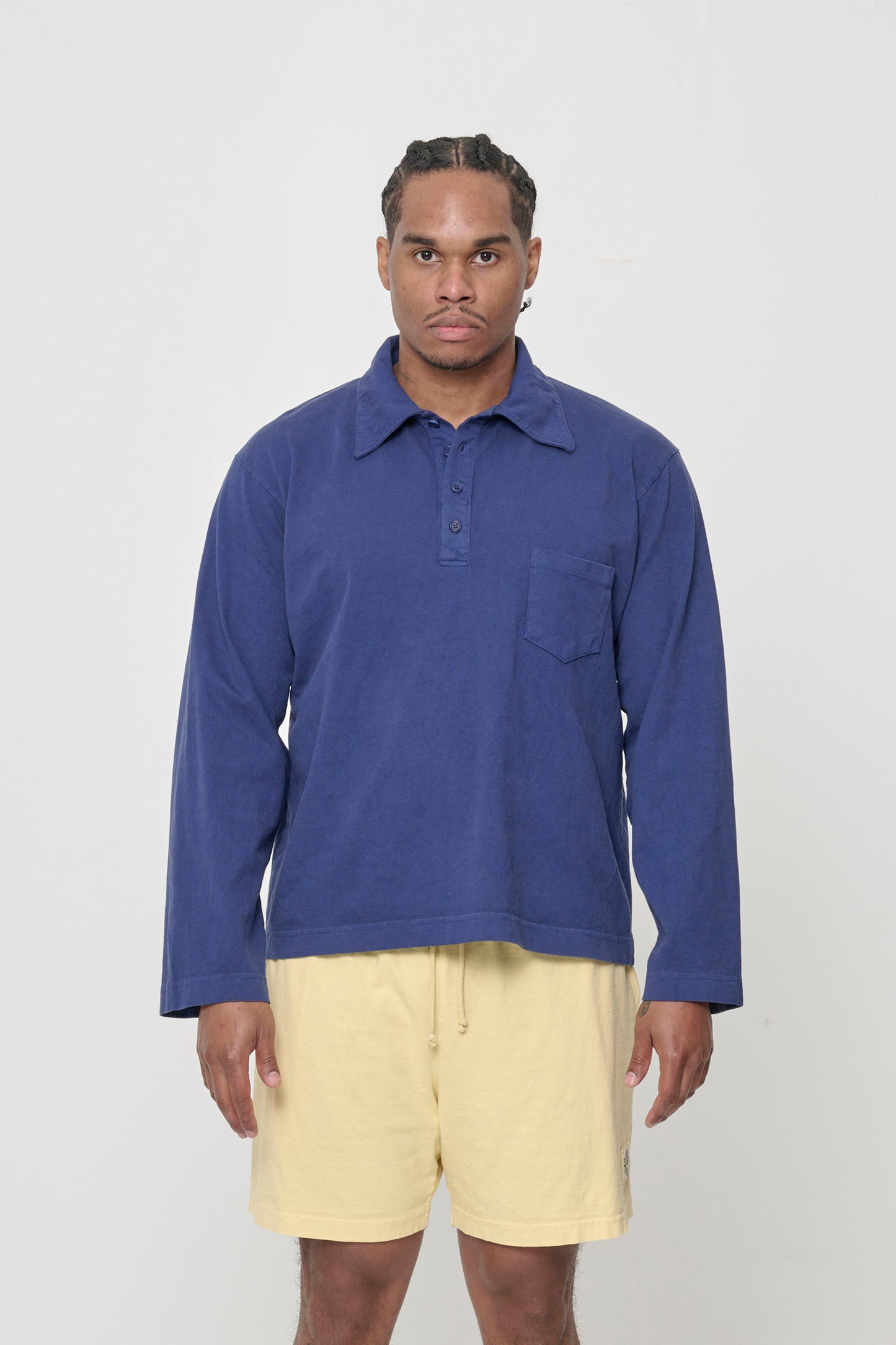 Front view of a 6' person wearing a size L Rugby Trash Polo in Washed Navy. Hem hits lower-mid hip.