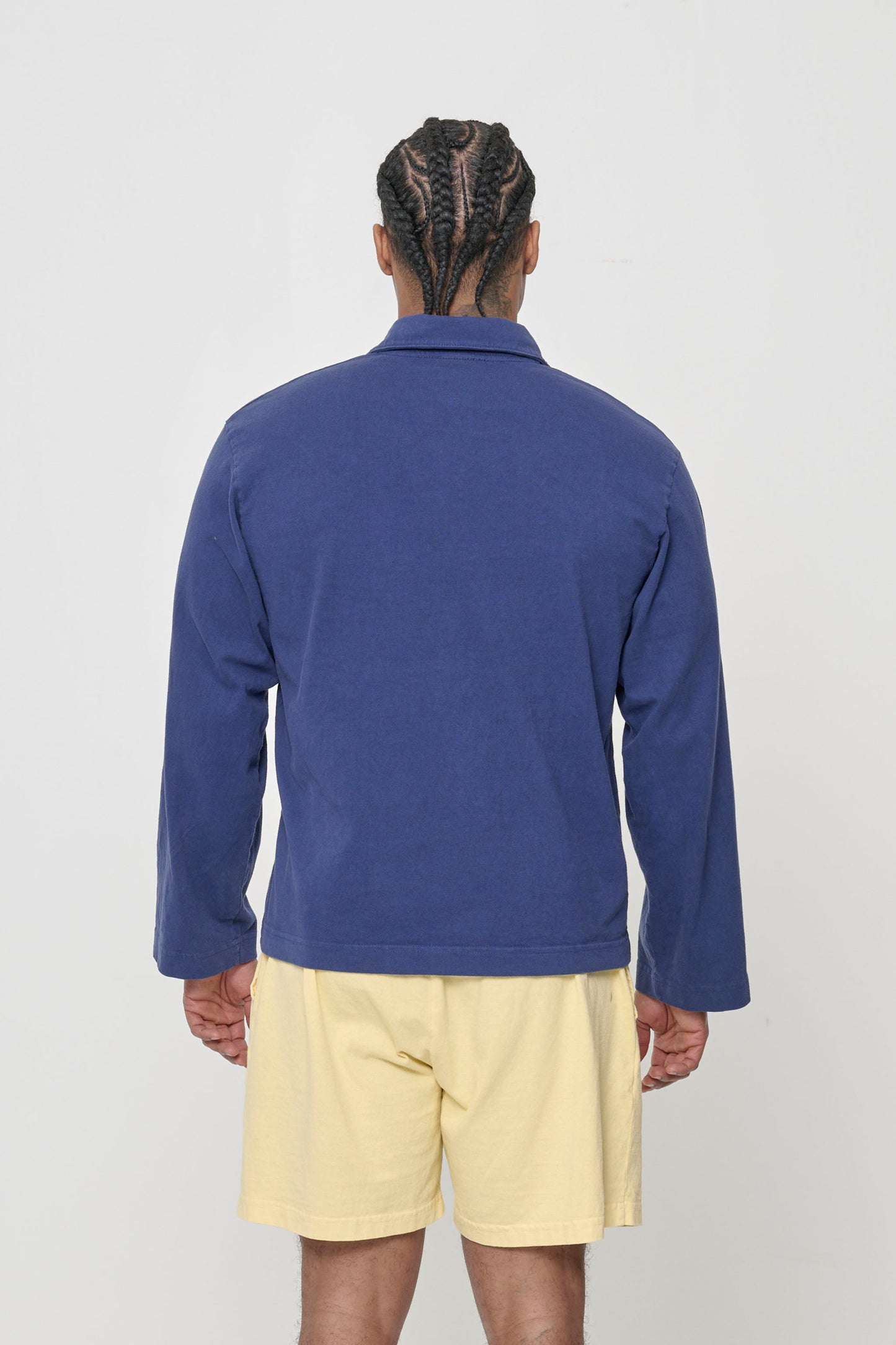 Washed Navy Rugby Trash Polo, back view on a person. Boxy fit.