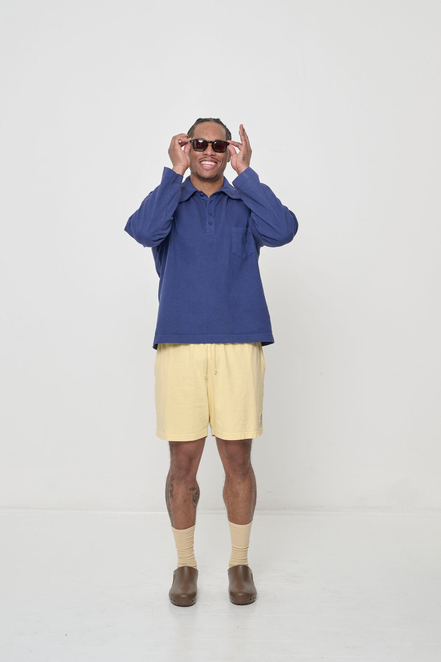 Man wearing Washed Navy Rugby Trash Polo with French Butter Everyday Shorts.