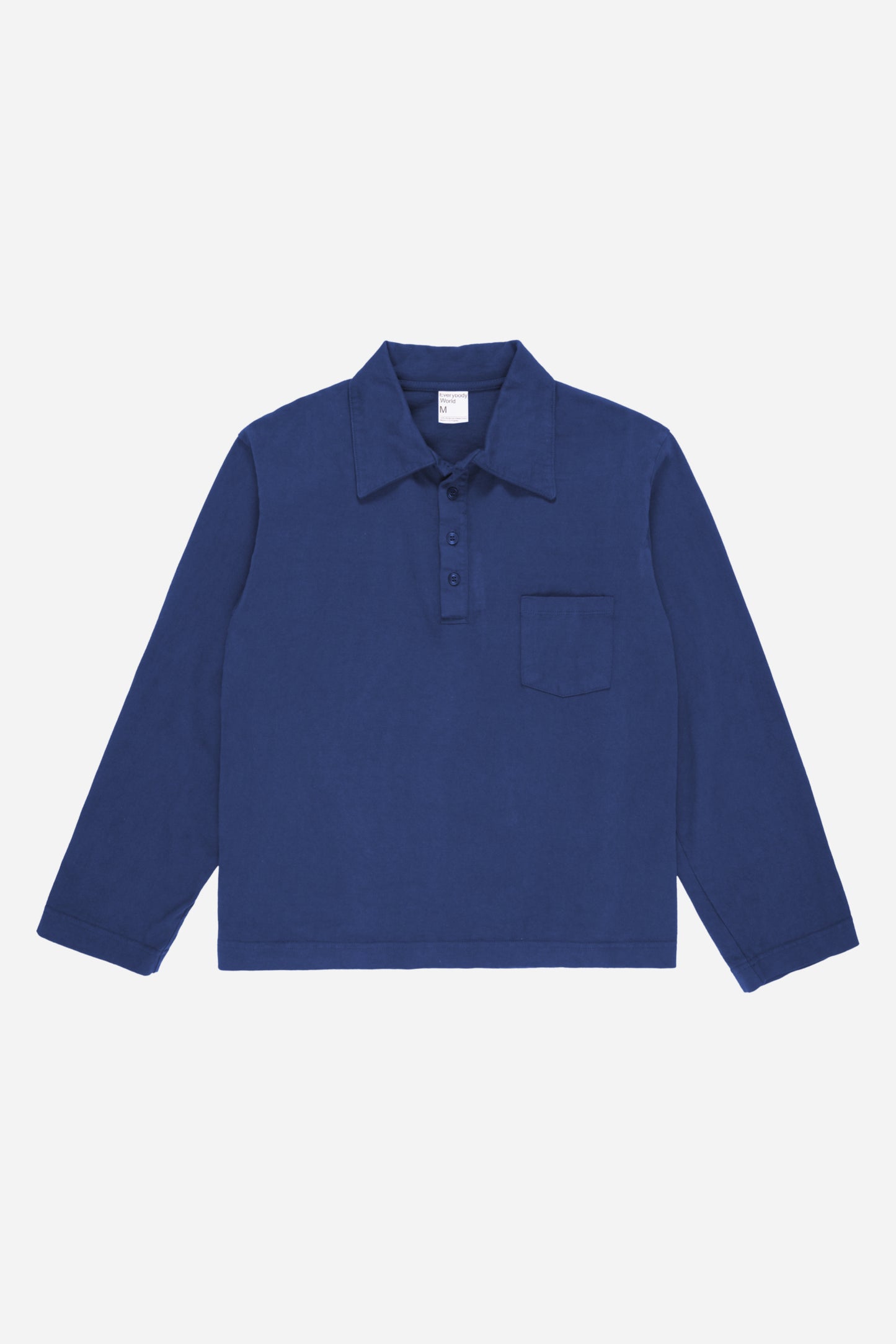 Flat lay of the Washed Navy Rugby Trash Polo, showing color, buttons, and front pocket.