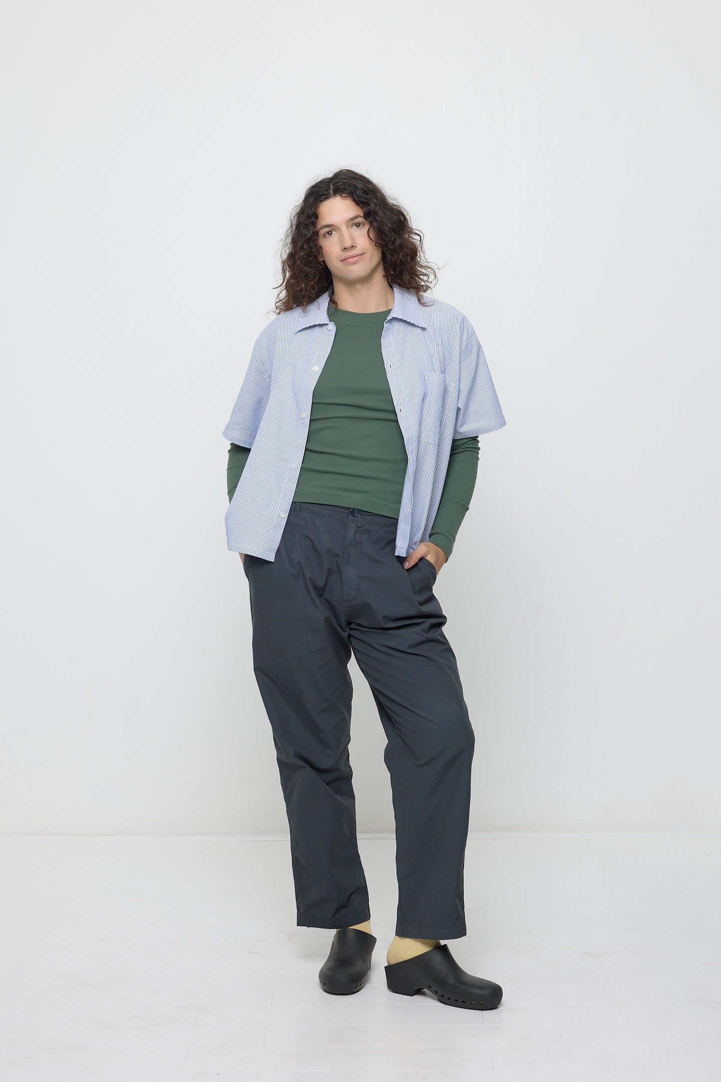 Person wearing open blue Short Sleeve Stripe Poplin Button Up Shirt, layered over Pine Rib Long Sleeve and Life Uniform Pants.