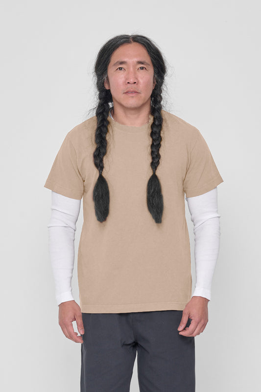 A 5'11" man in a size M Sand Storm Short Sleeve Trash Tee. Hem at lower hip.