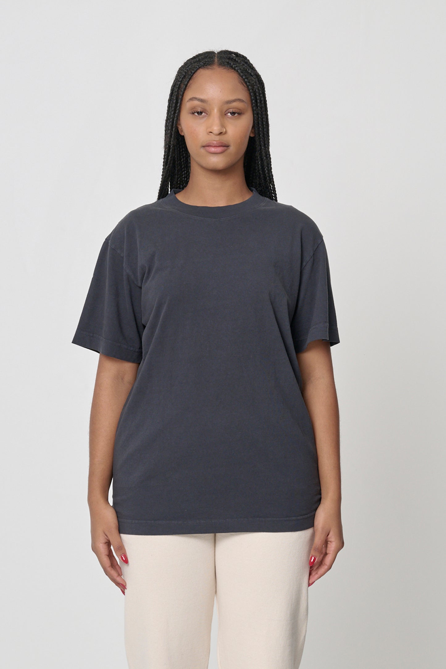 Front view of a woman wearing the Short Sleeve Trash Tee in Slate, showcasing its relaxed fit and dark gray, almost black color.