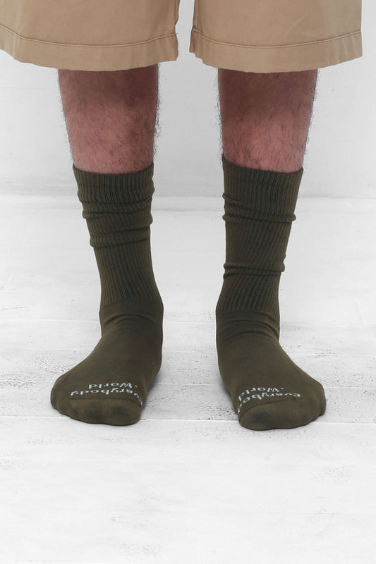 Olive Socks, branded 'Everybody.World' in white at the toe, mid-calf high.