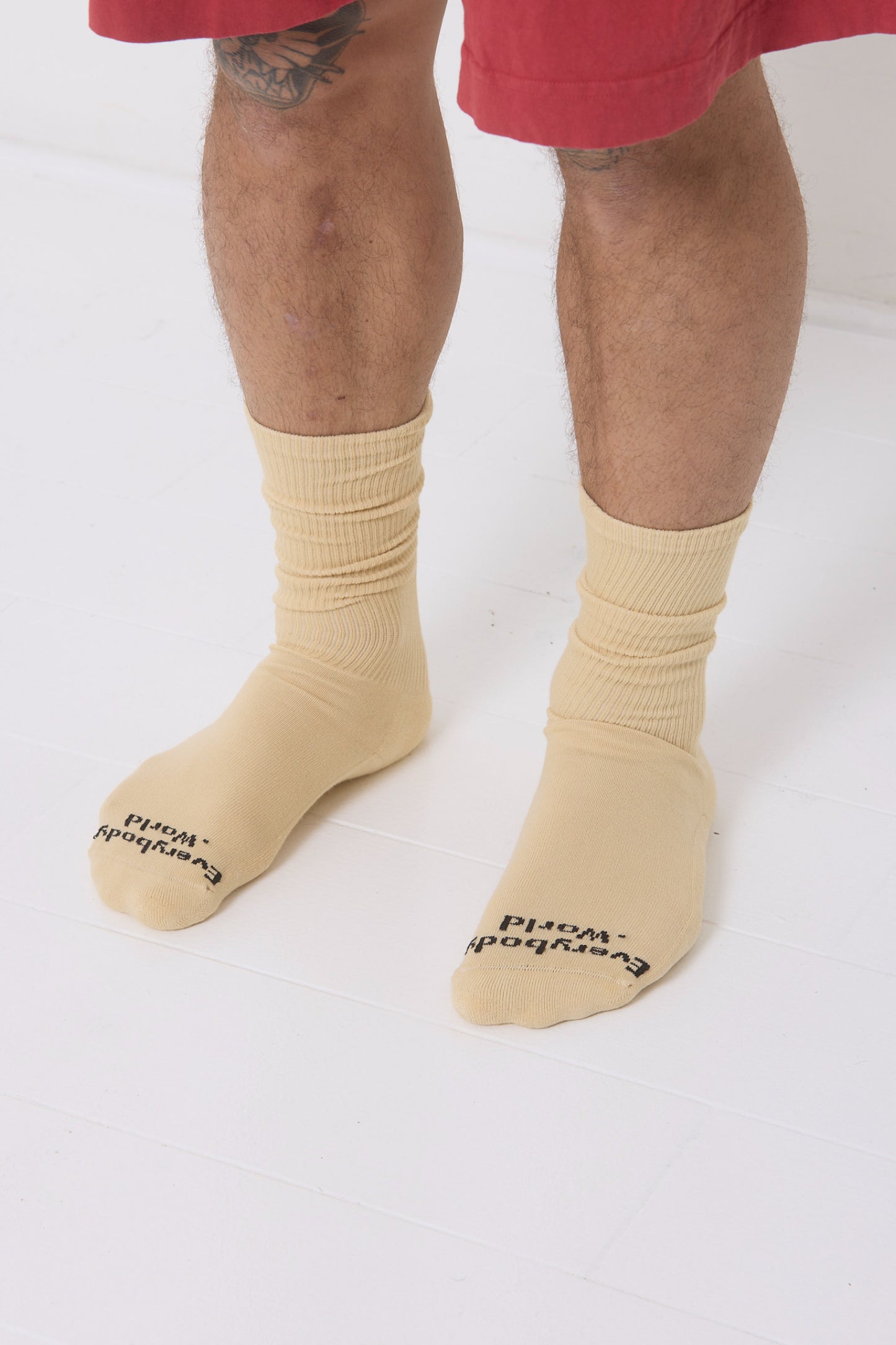 Turtle Dove Squishy Socks, branded 'Everybody.World' in black, at the toe, shown on a person's lower legs.