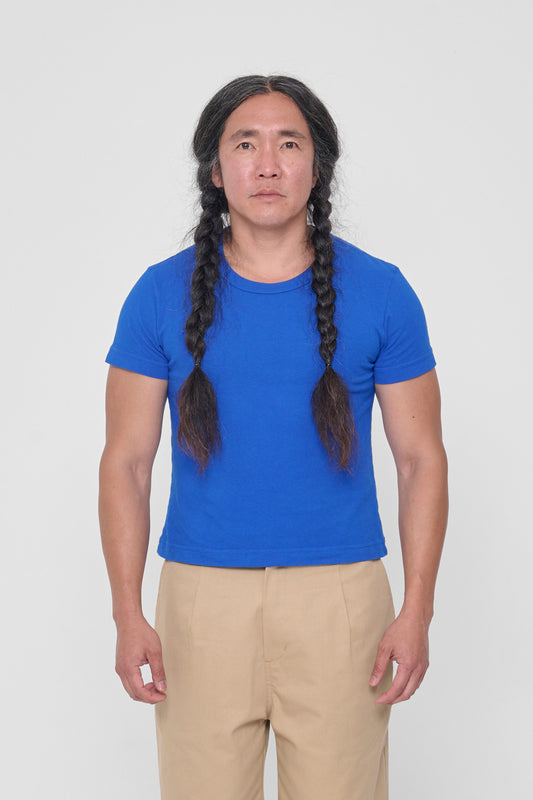 A 5'11" man in a size L Lapis Tailored Trash Tee. Hem hits his upper hip.