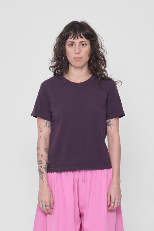 A 5'6" woman in a size S Mulberry Tailored Trash Tee. Hem ends at her upper hip.
