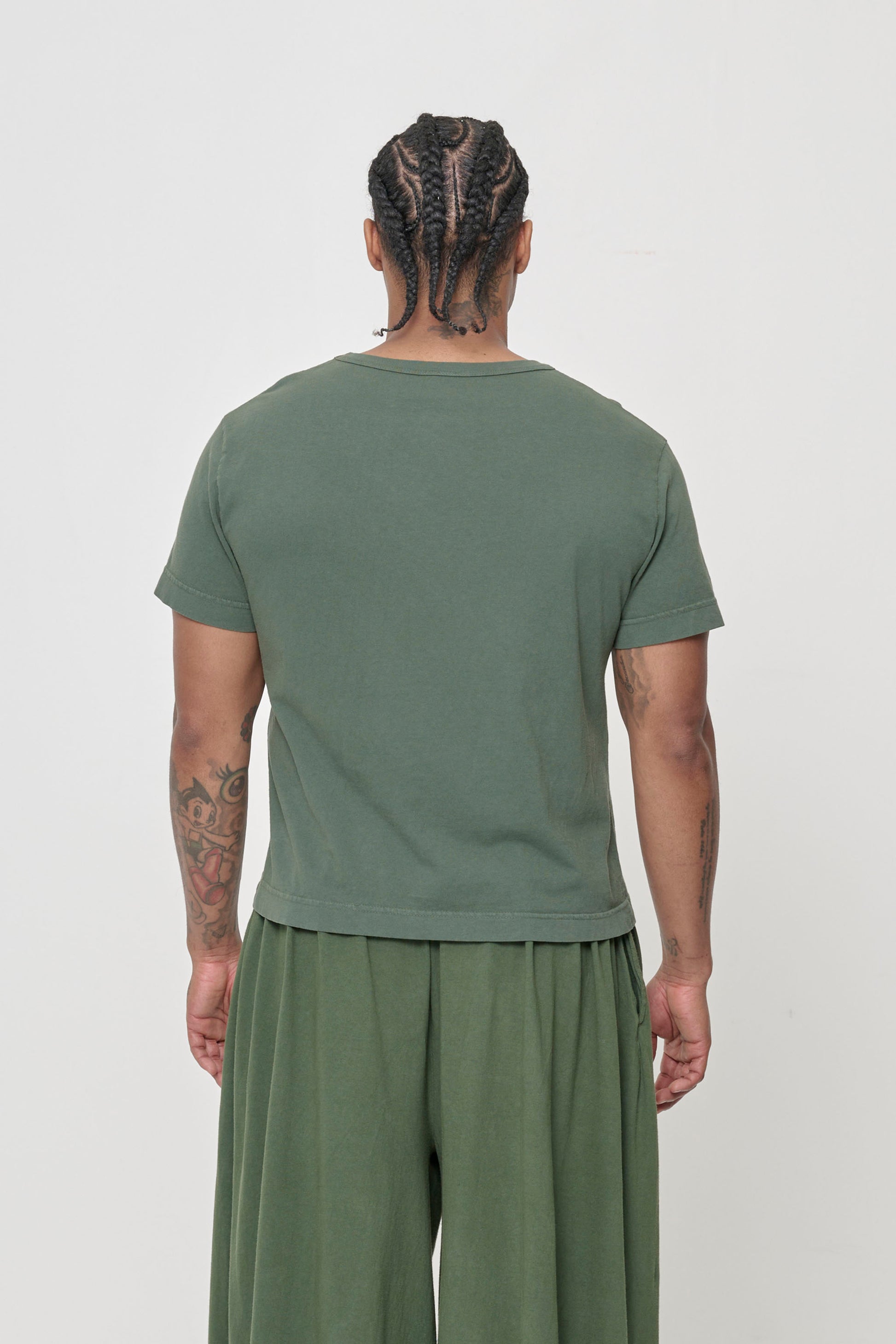 Tailored Trash Tee in Pine, back view on a person - fitted across upper back and relaxed at middle and lower back