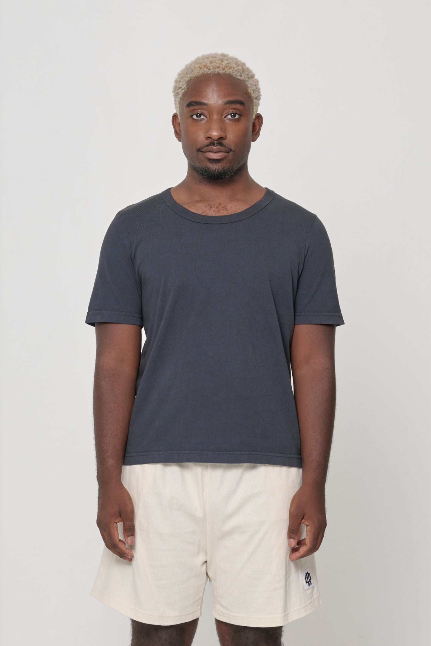 5'9" man wearing a Slate Tailored Trash Tee in Size XL, shirt hem hits his lower middle hip.