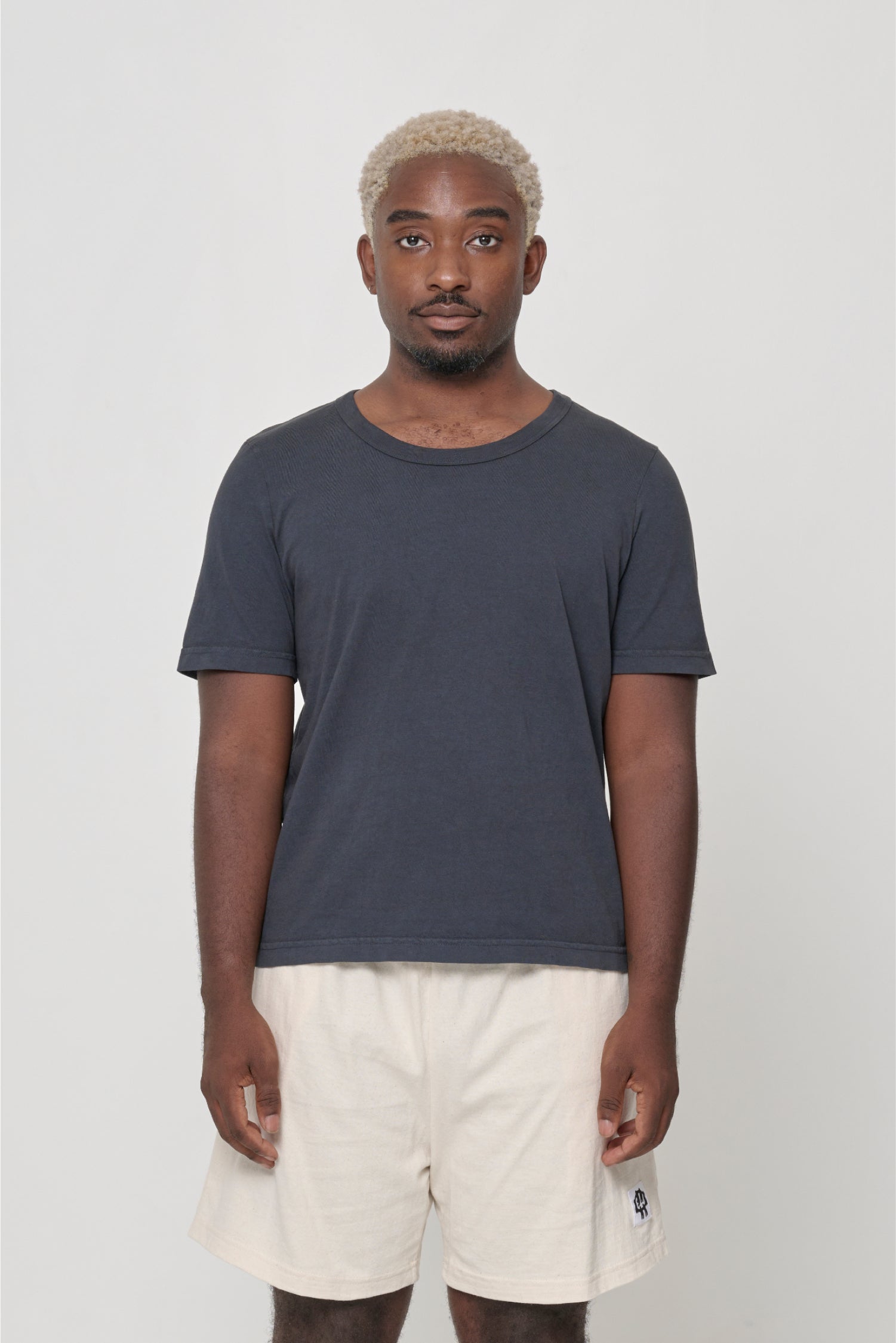 5'9" man wearing a Slate Tailored Trash Tee in Size XL, shirt hem hits his lower middle hip.