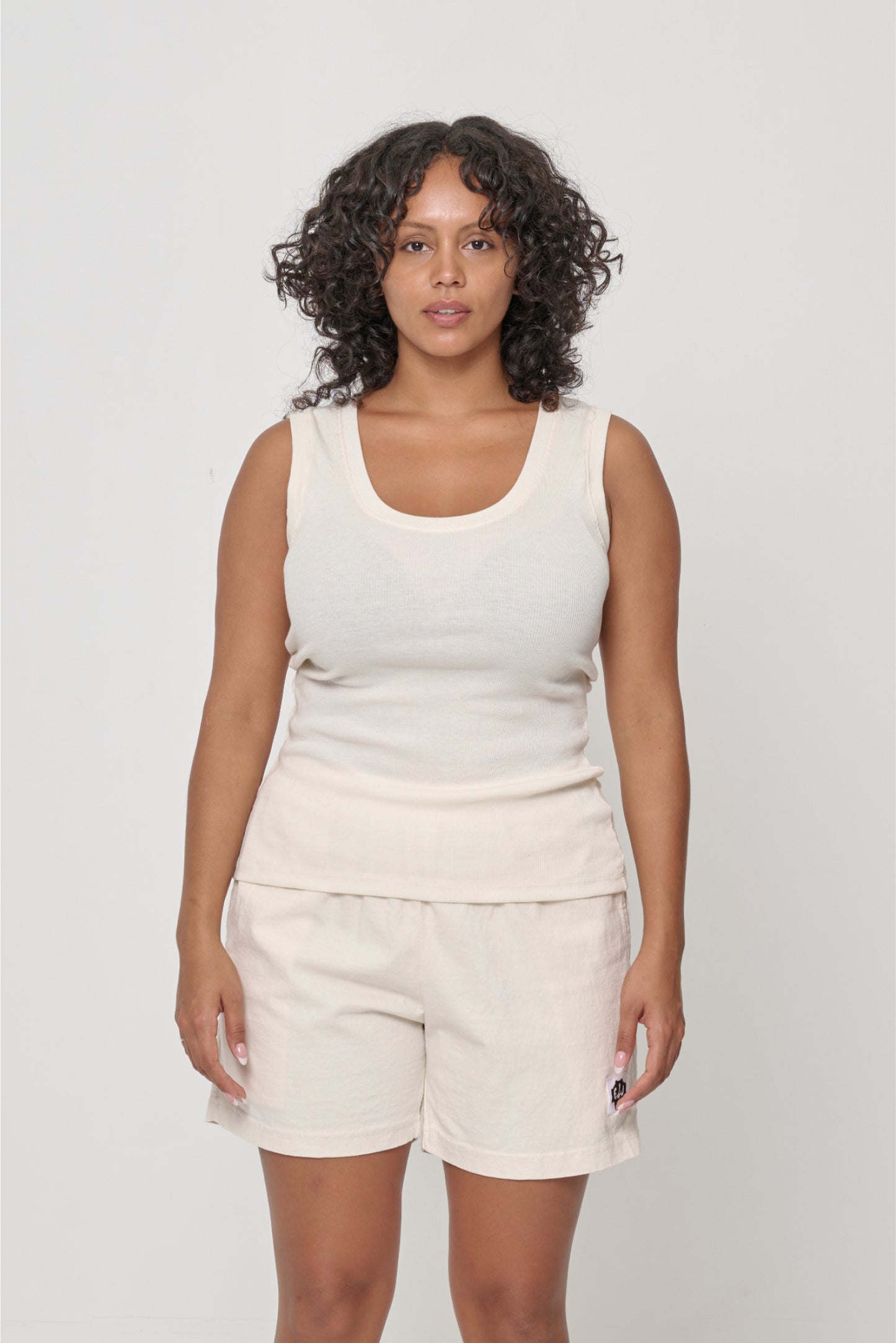 Front view of a 5'7" woman wearing a size M The Tank in Natural. Hem hits her lower middle hips.