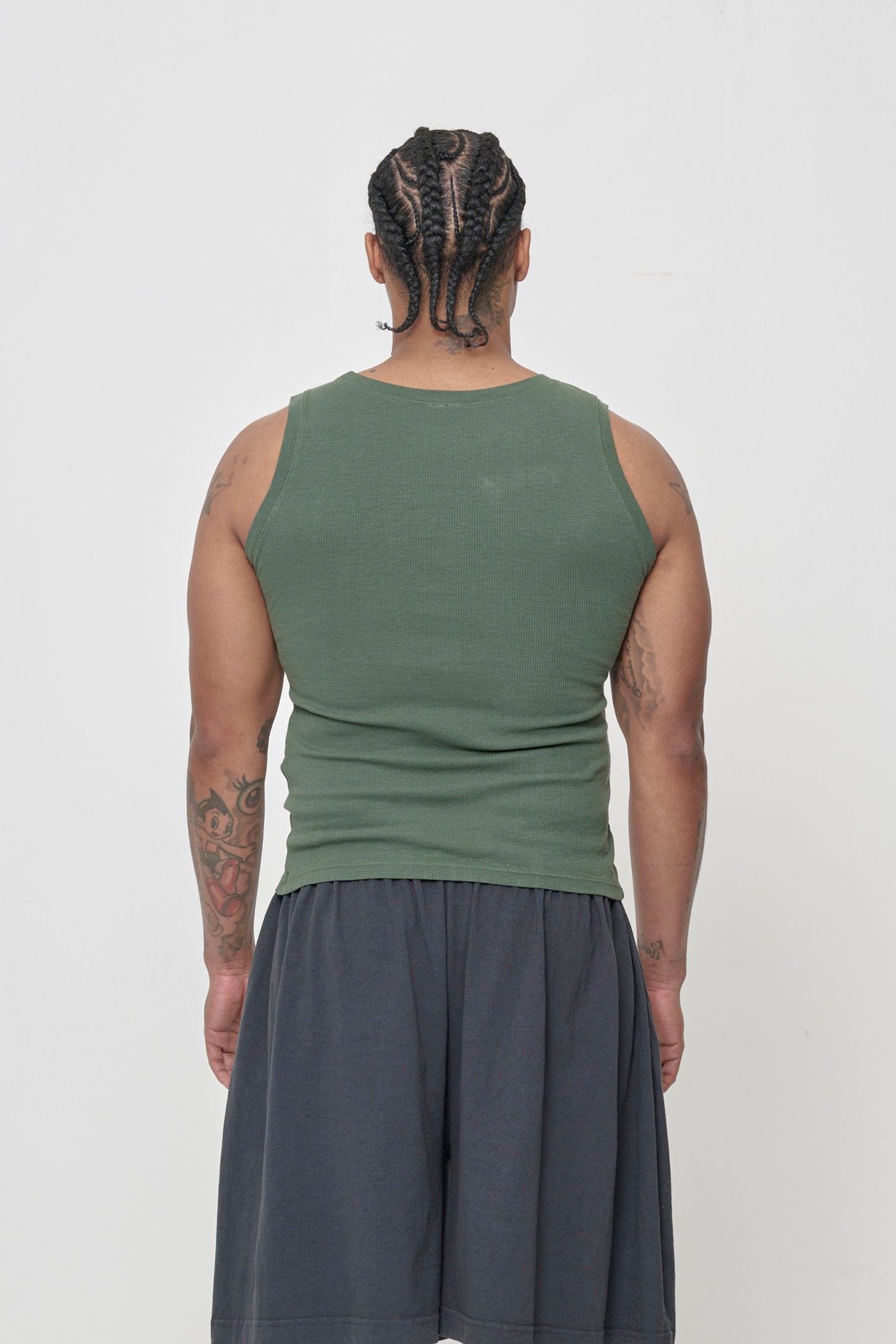 Back view: a person in a Pine The Tank, snug fit throughout.