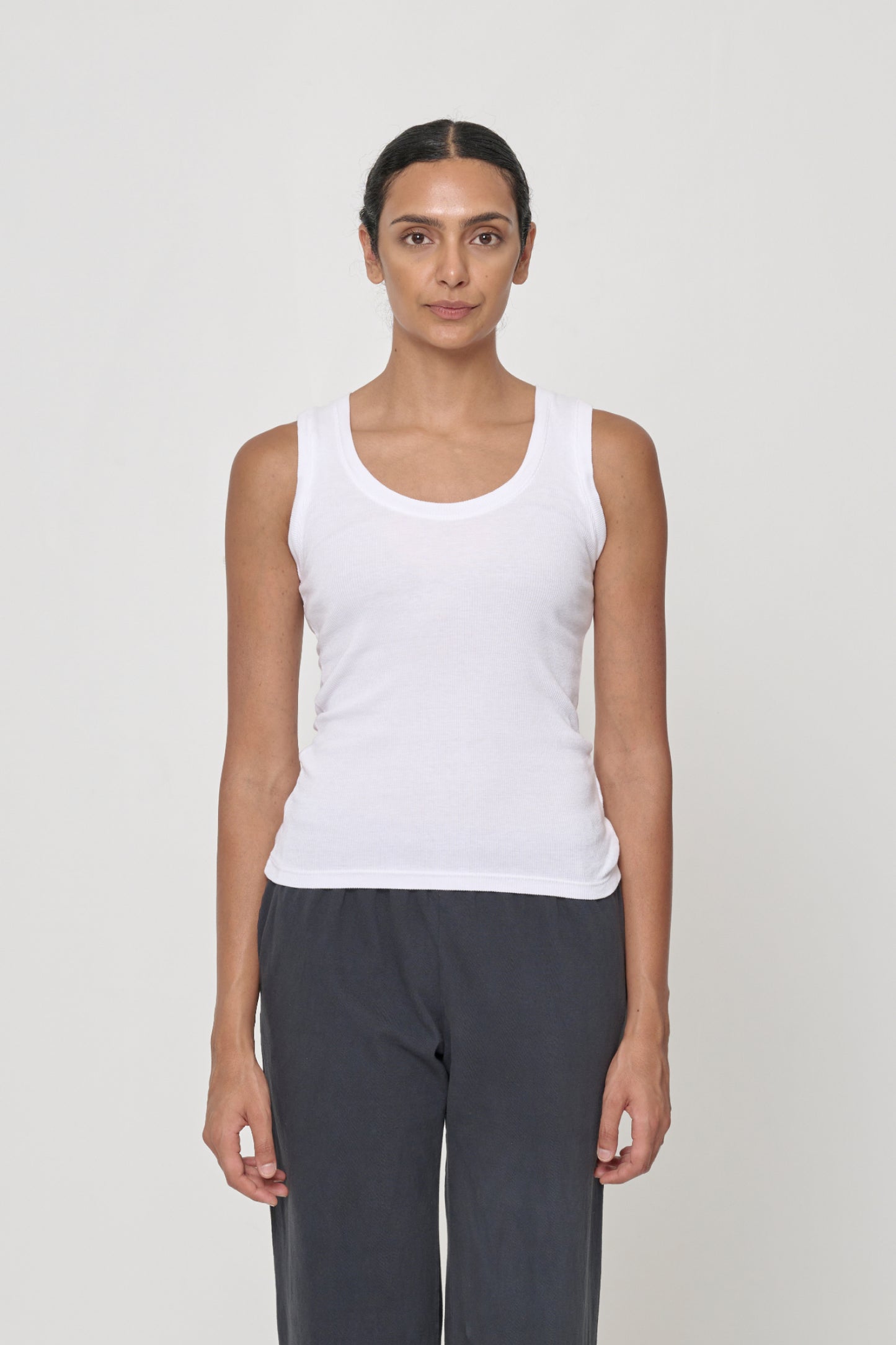Front view of a 5'10" woman wearing a size M The Tank in White. Hem hits her upper middle hips.
