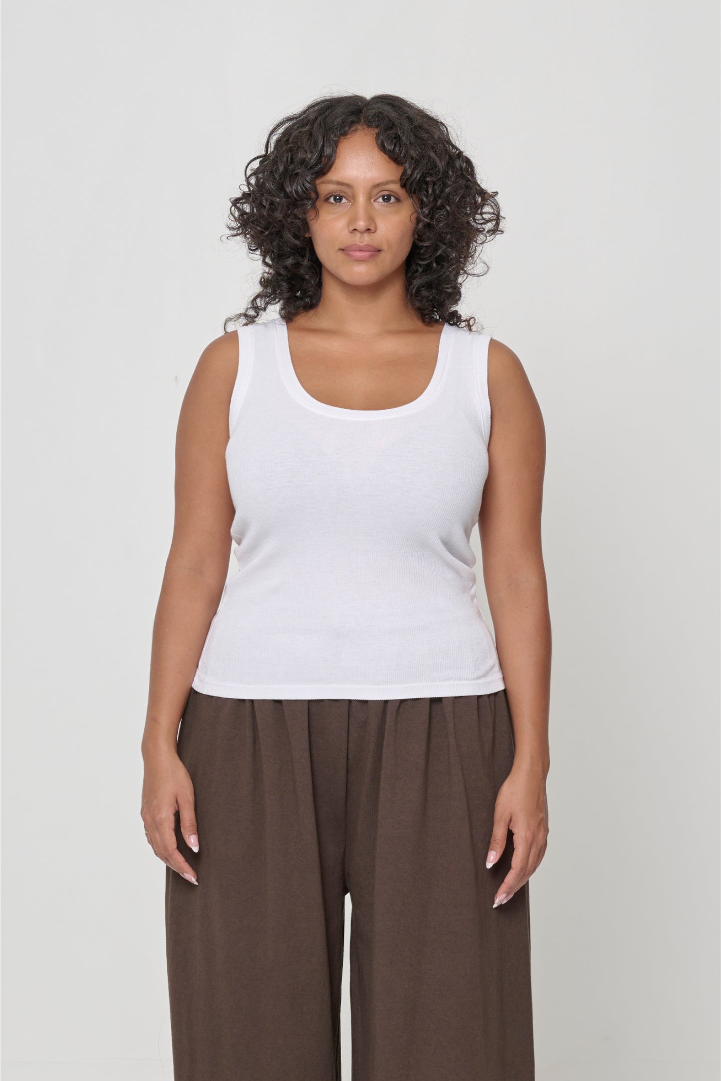 Front view of a 5'7" woman wearing a size M The Tank in White. Hem hits her middle hips.