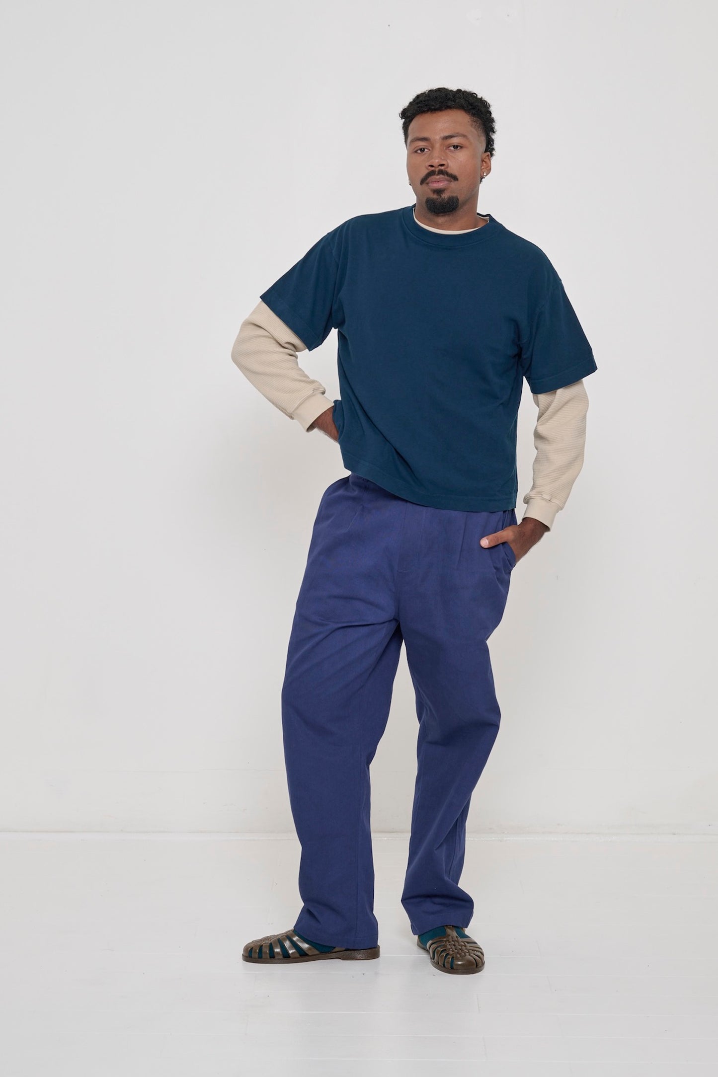 Man in Boxier Trash Tee layered over Oat Thermal Long Sleeve Boxier Trash Tee with Cotton Twill Life Uniform Pants.