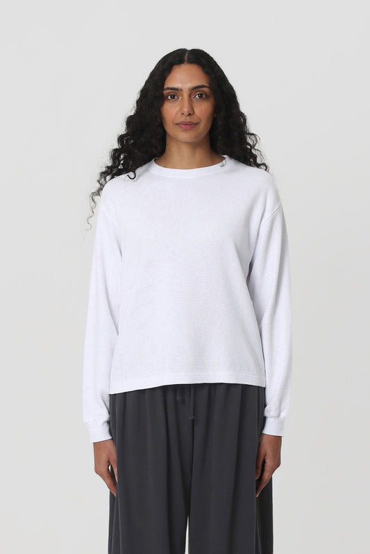 5'10" woman in a size S White Thermal Long Sleeve Boxier Trash Tee. Hem hits the upper-middle hip.